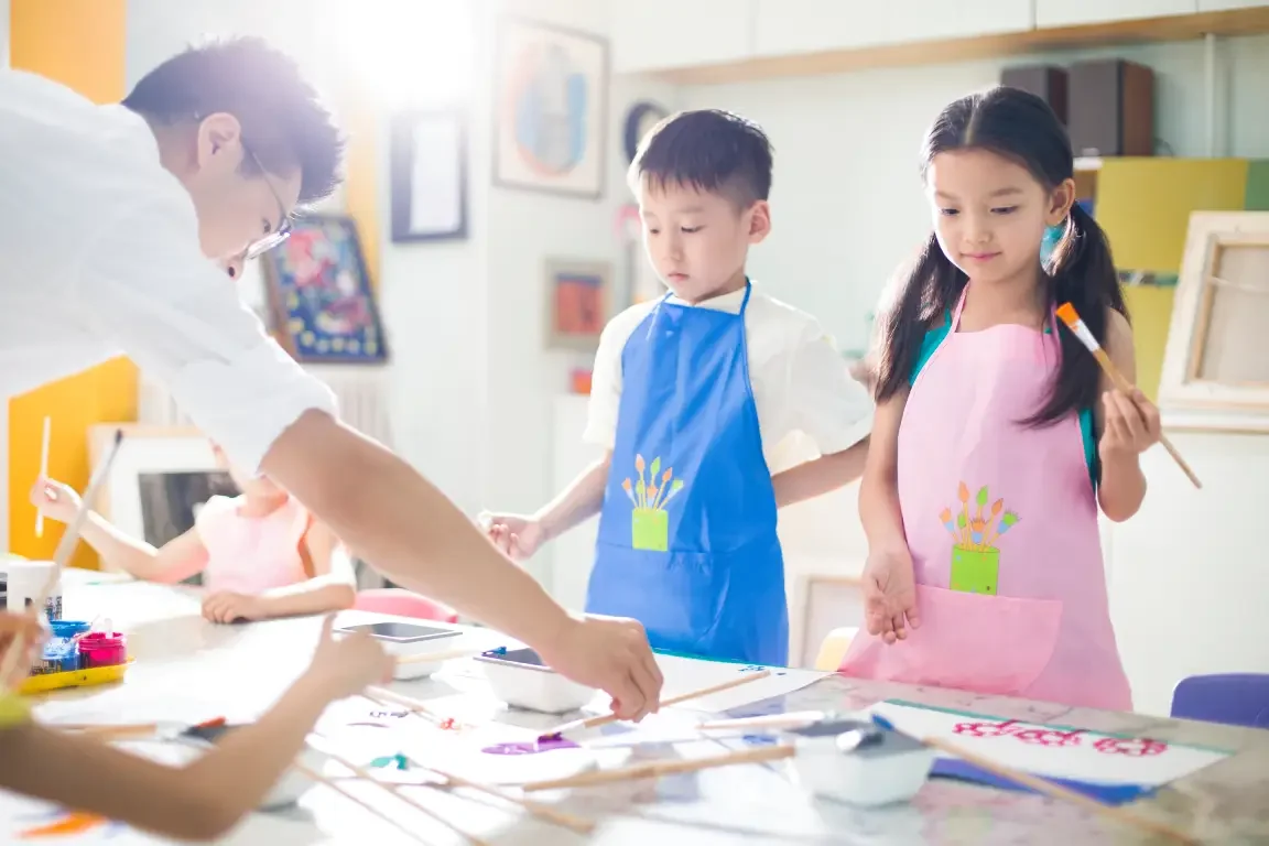 Children at different ages doing art therapy, with painting as the main activity guided by a therapist in Singapore