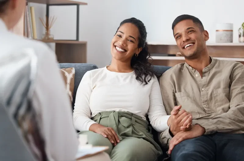 Couple attending a couples therapy session to strengthen communication and navigate parenting and family challenges.