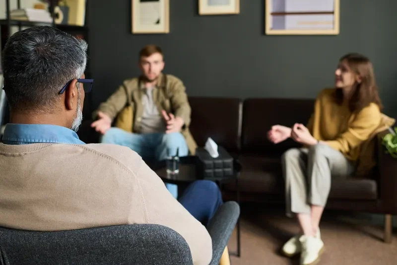 Couple attending a therapy session with a mental health professional to improve communication.