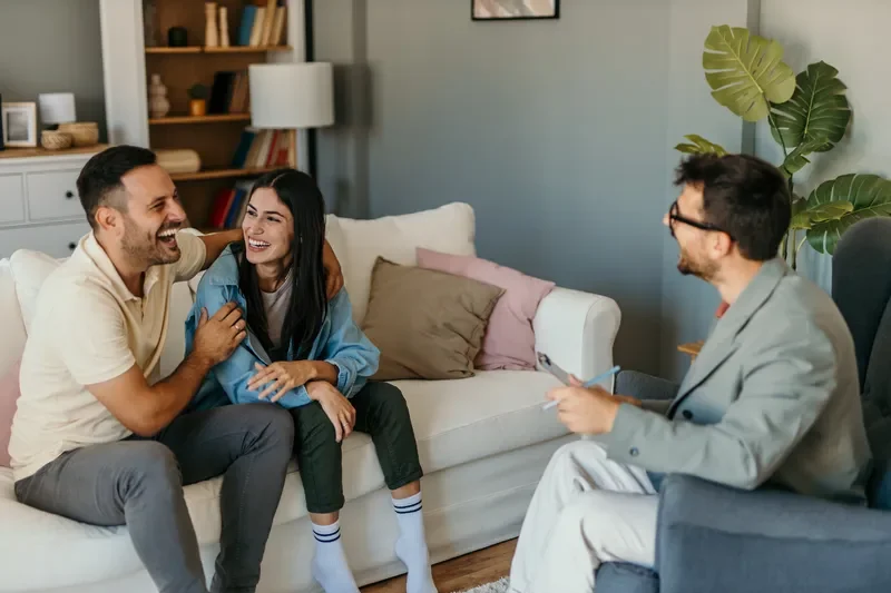 Couple attending a couples therapy session to strengthen communication and navigate parenting and family challenges.