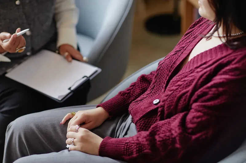 Client meeting with a mental health professional to discuss therapy options and emotional well-being.