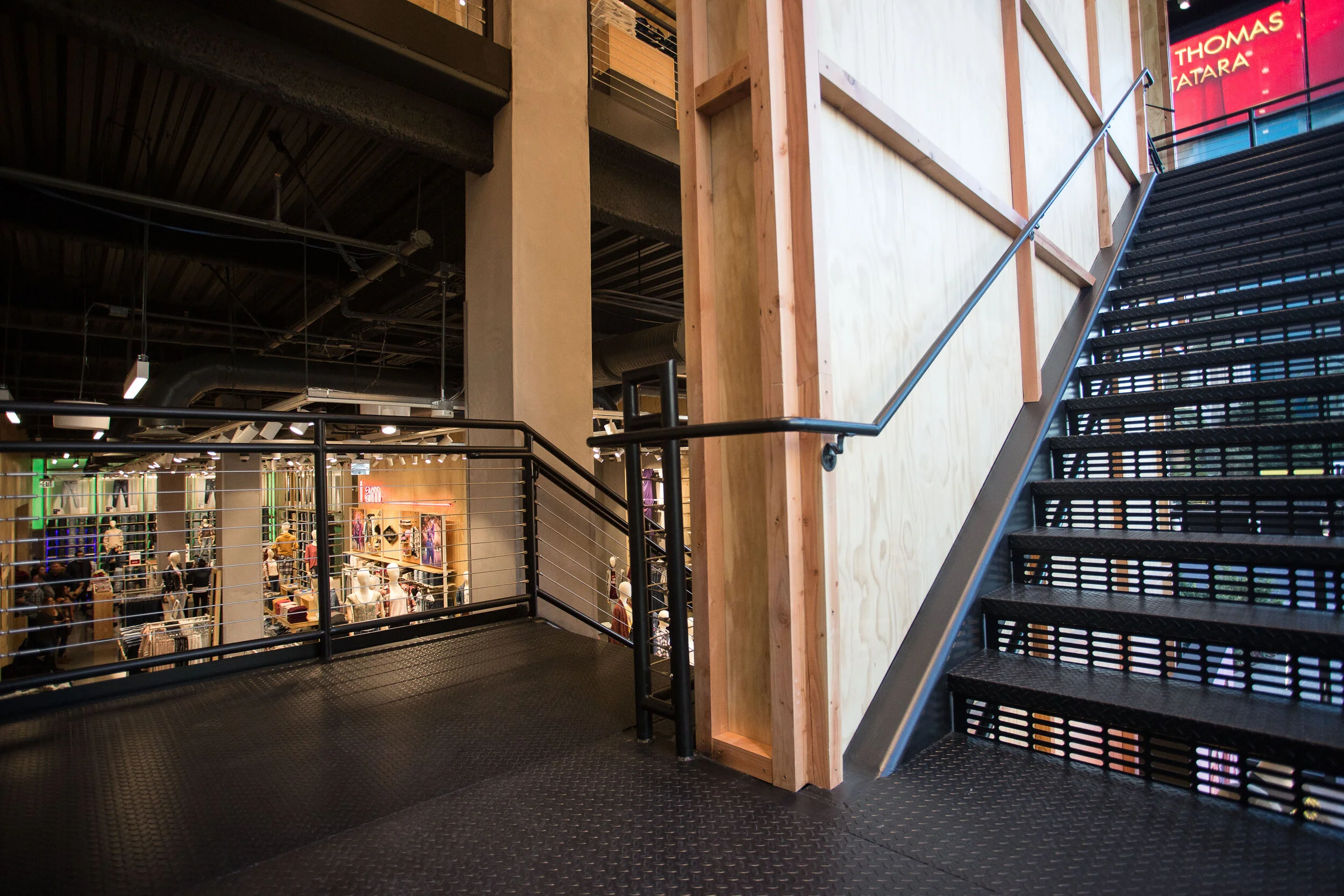 Industrial steel staircase connecting floors inside the American Eagle Flagship Store Las Vegas.