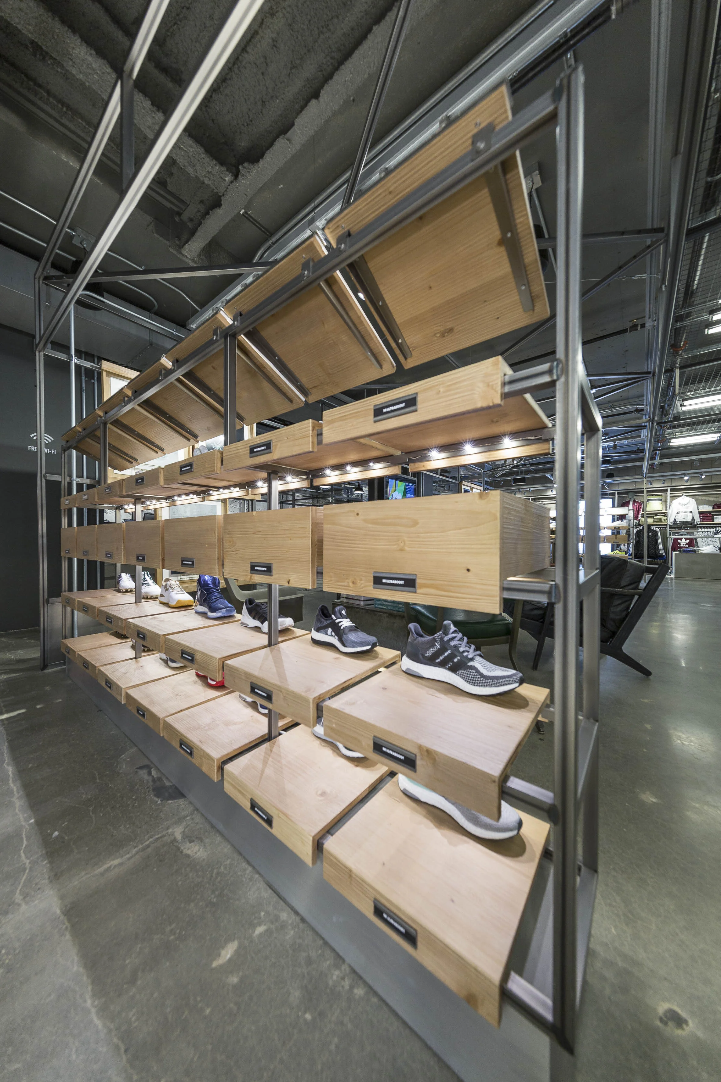 Modular wooden footwear display system inside Adidas Flagship NYC store