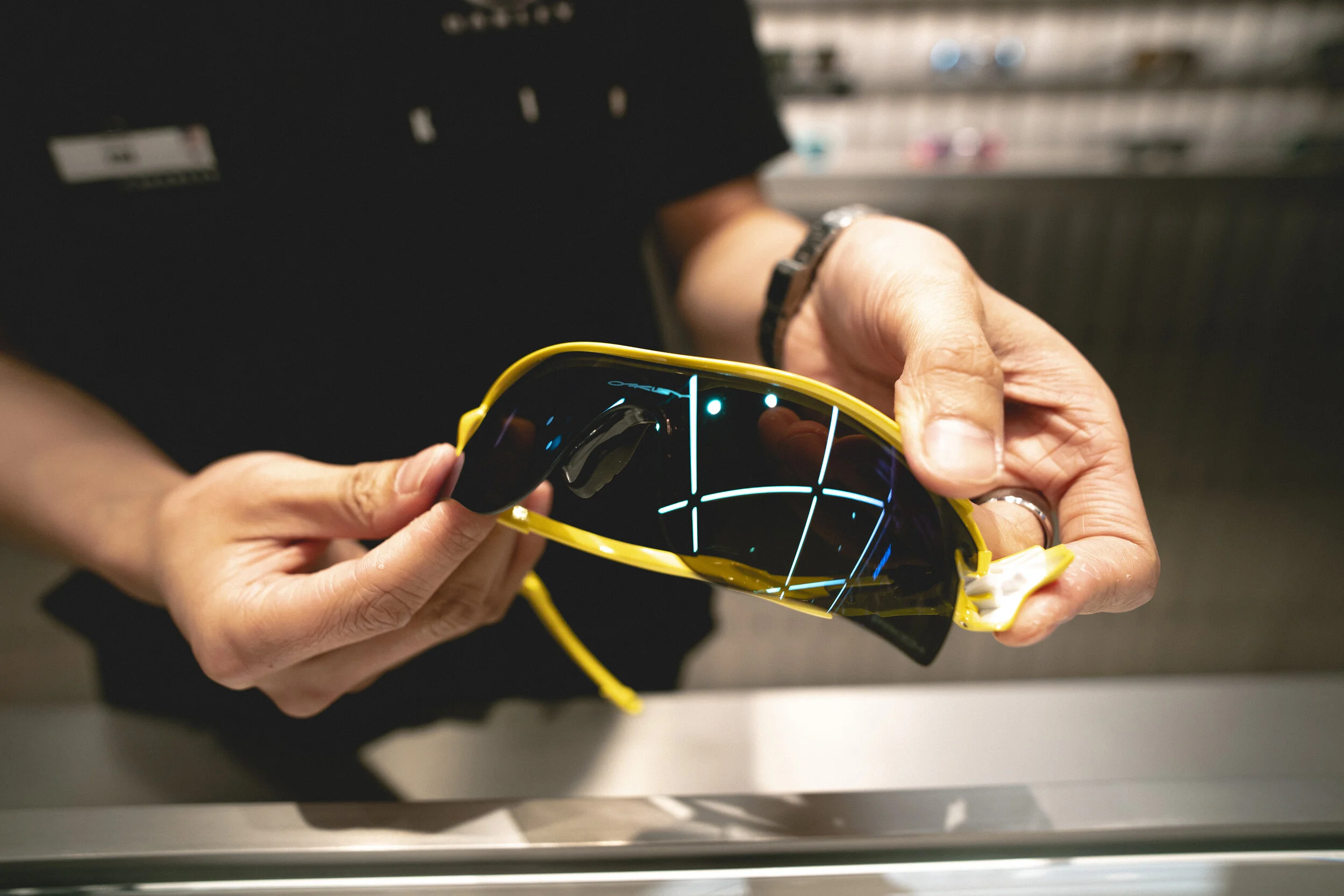Oakley staff demonstrating eyewear fitting and lens technology at the Shibuya flagship store