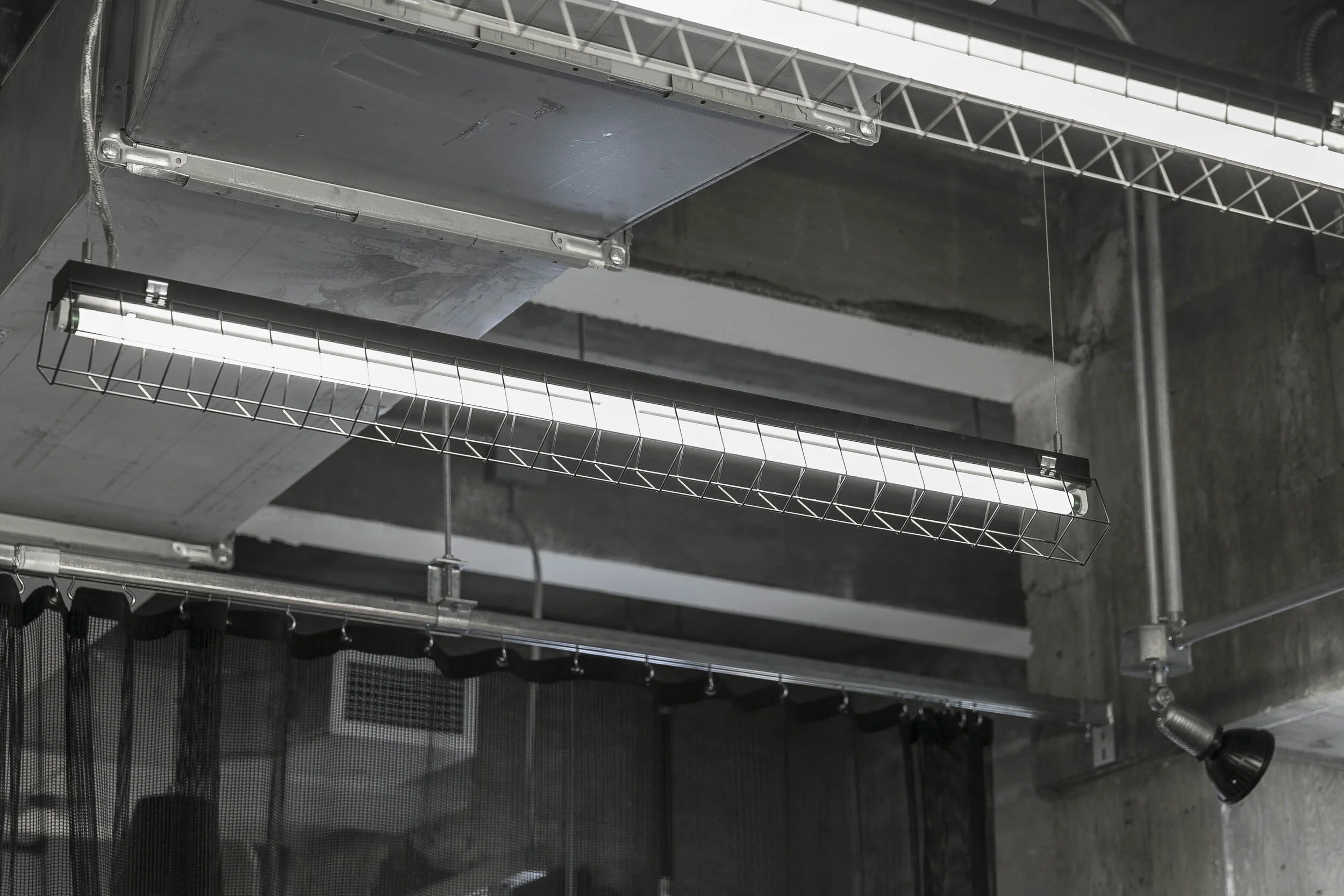 Industrial lighting and exposed services detail at Adidas Flagship NYC