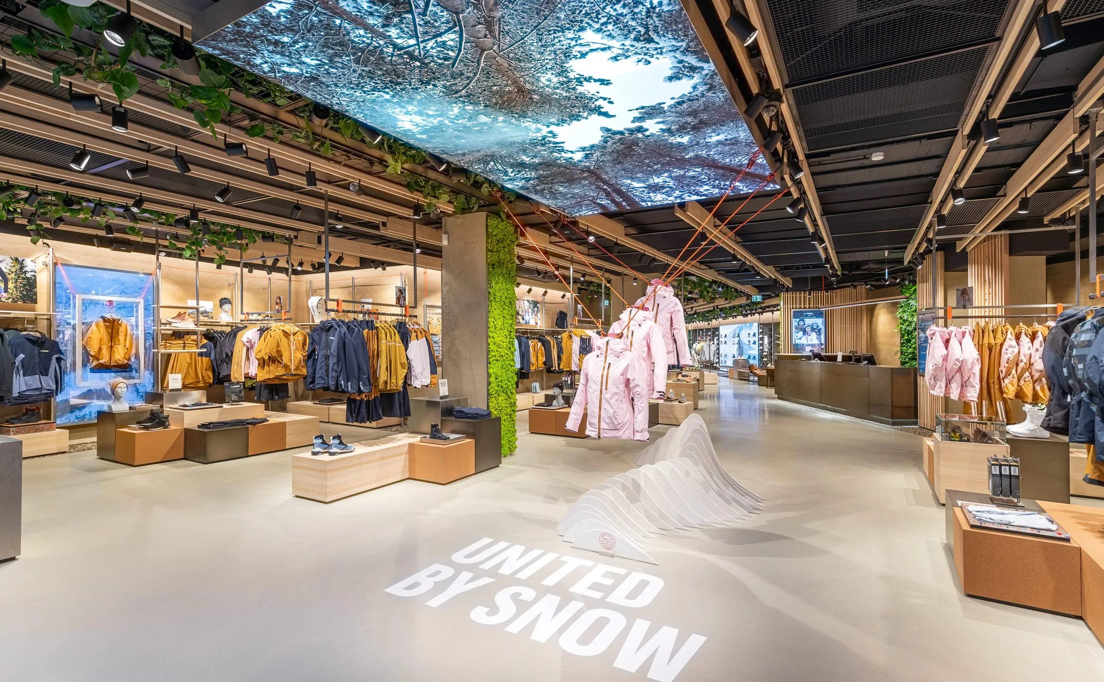 Wide interior view of the Adidas Terrex Munich store featuring the United by Snow campaign and immersive retail layout.