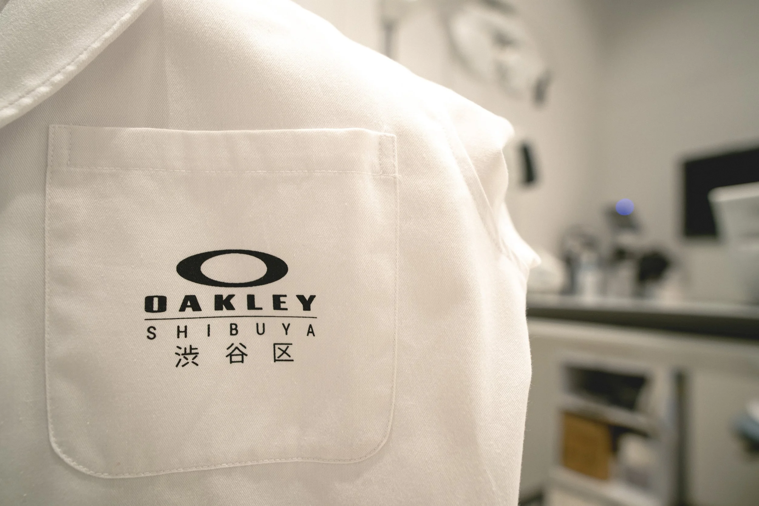 Close-up of Oakley Shibuya branded apparel detail with logo and Japanese typography