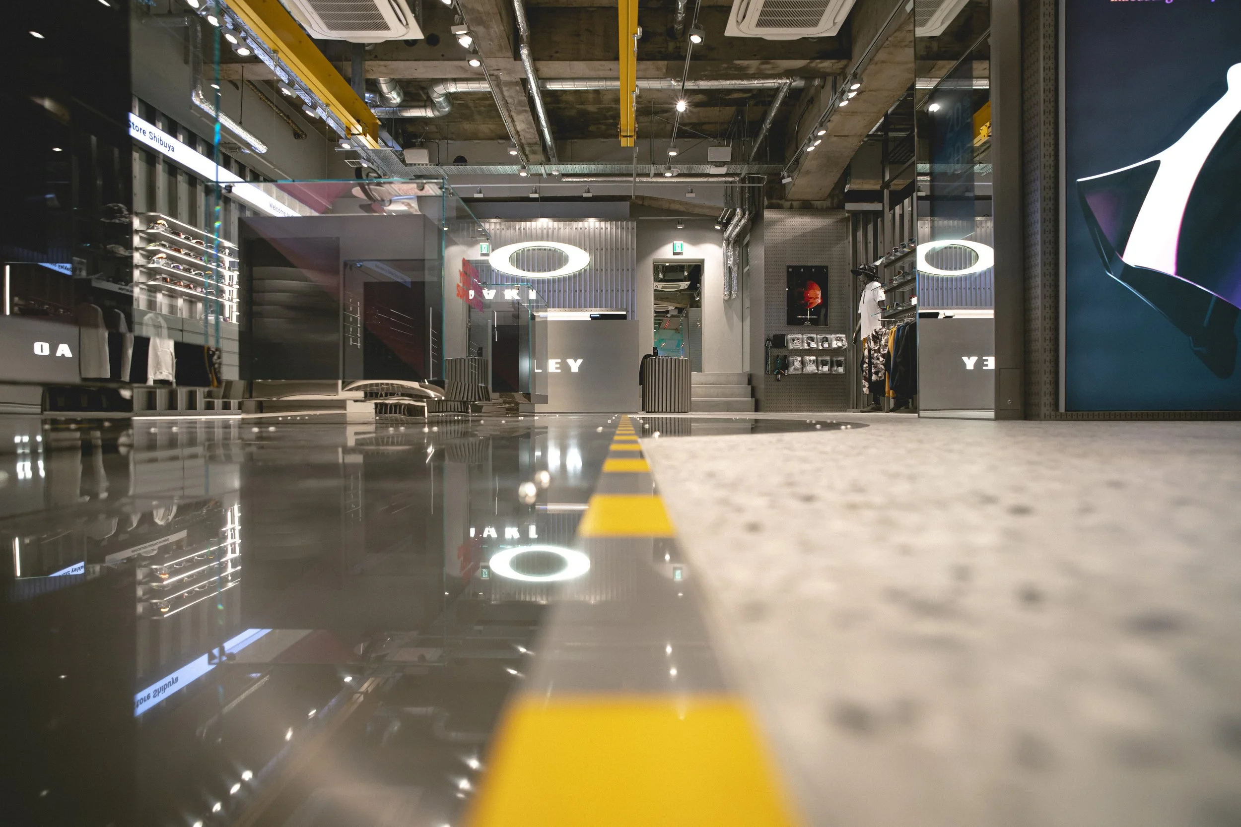 Low angle view of polished concrete floor and interior layout inside Oakley Shibuya flagship store