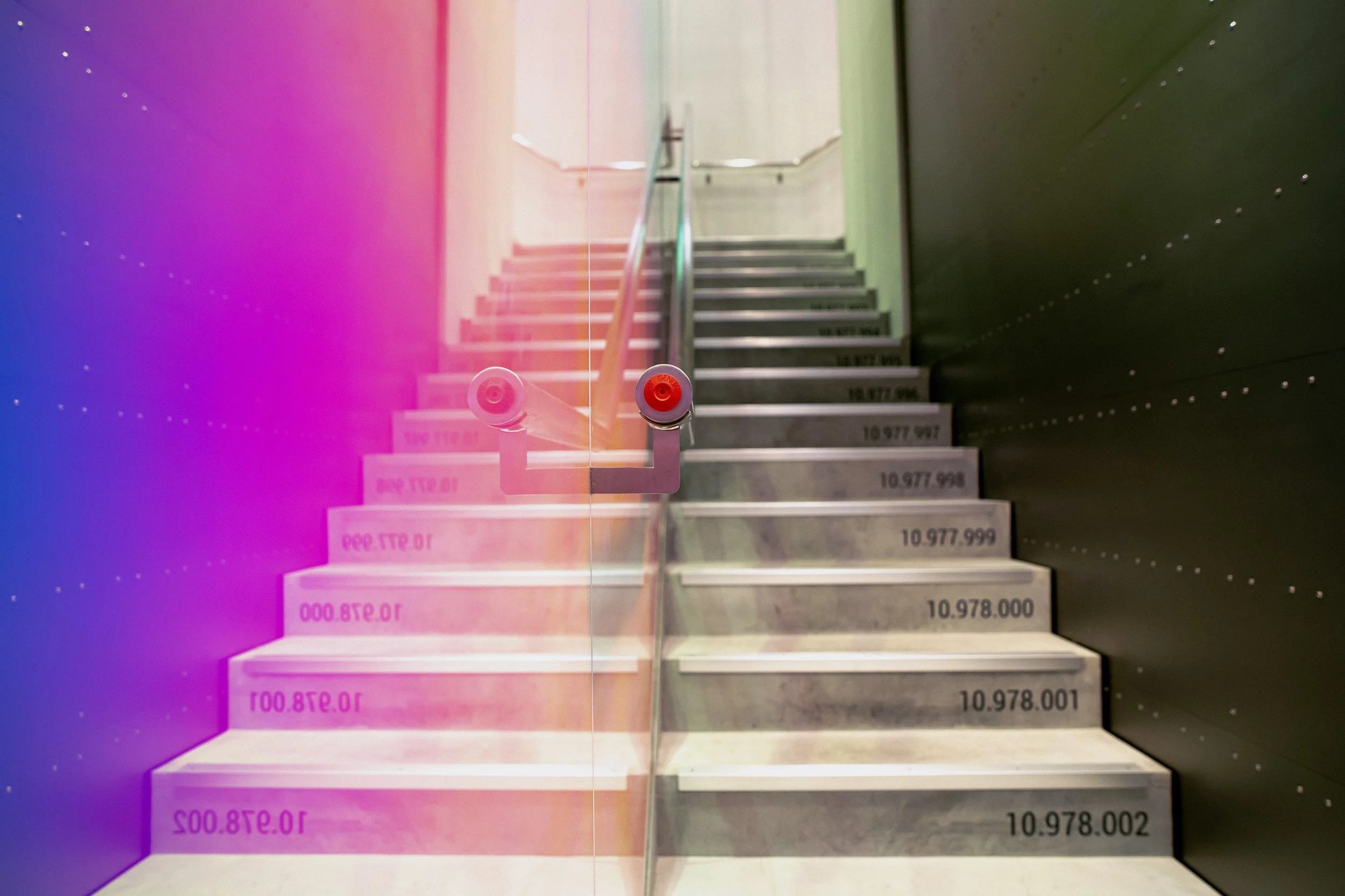 Architectural staircase installation inside the Oakley flagship store Shibuya with color light effects