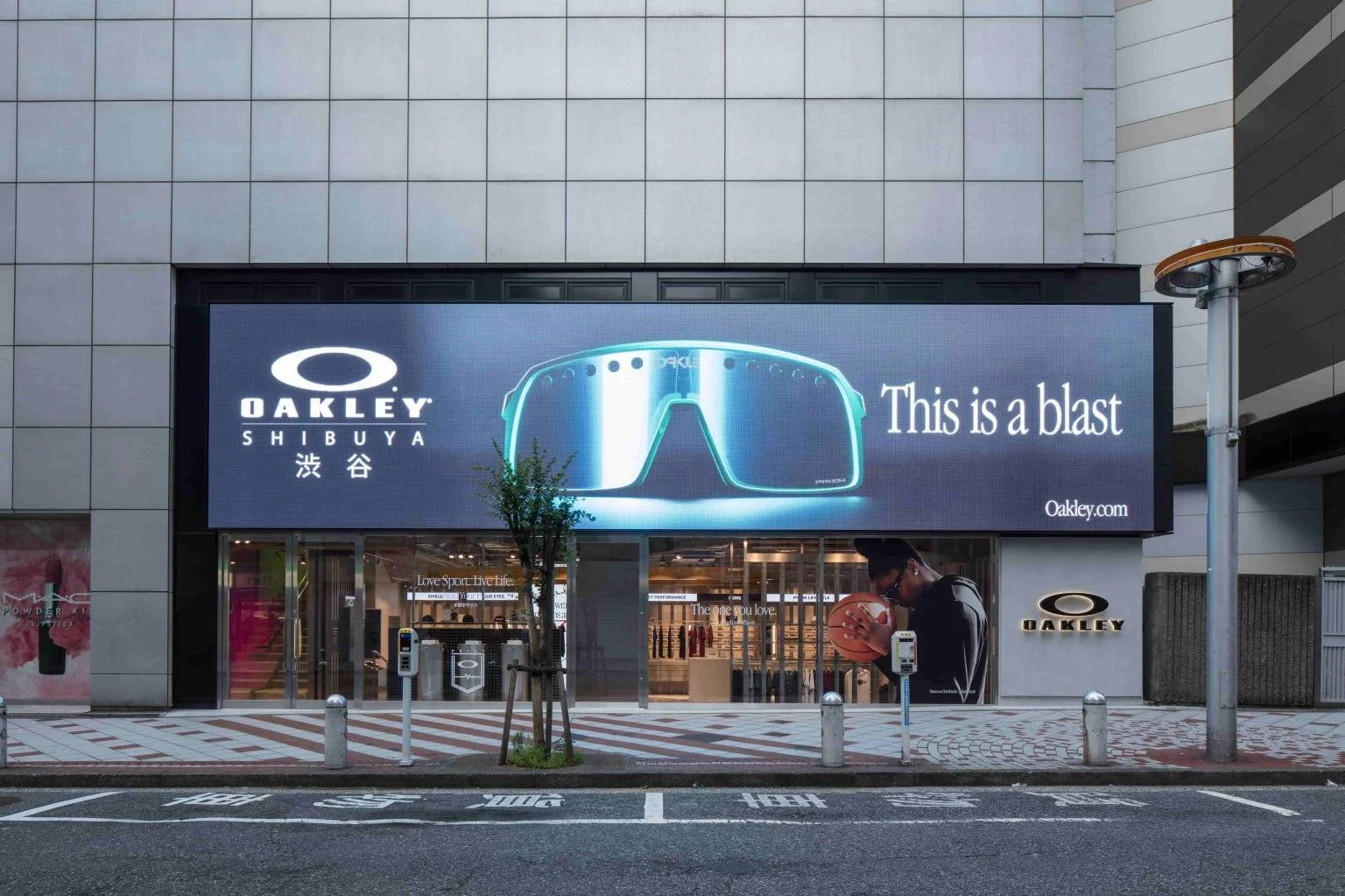 Exterior of the Oakley flagship store in Shibuya Japan with large LED screen and street frontage