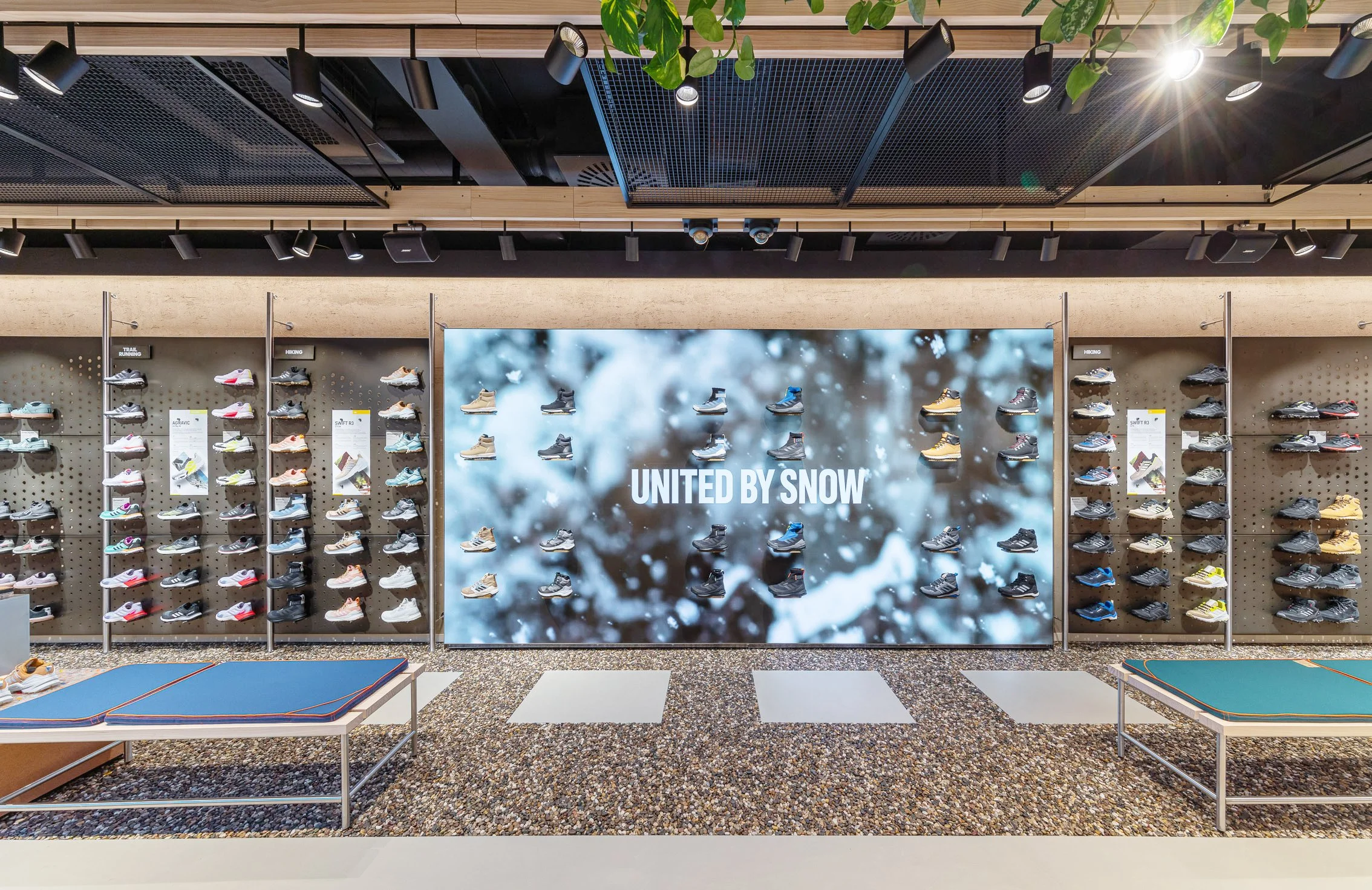 United by Snow campaign wall inside the Adidas Terrex Munich store displaying a full range of outdoor footwear.