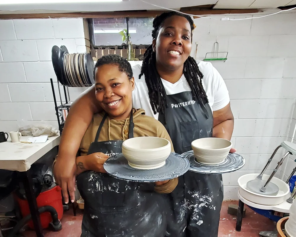 Two students with their finished pots