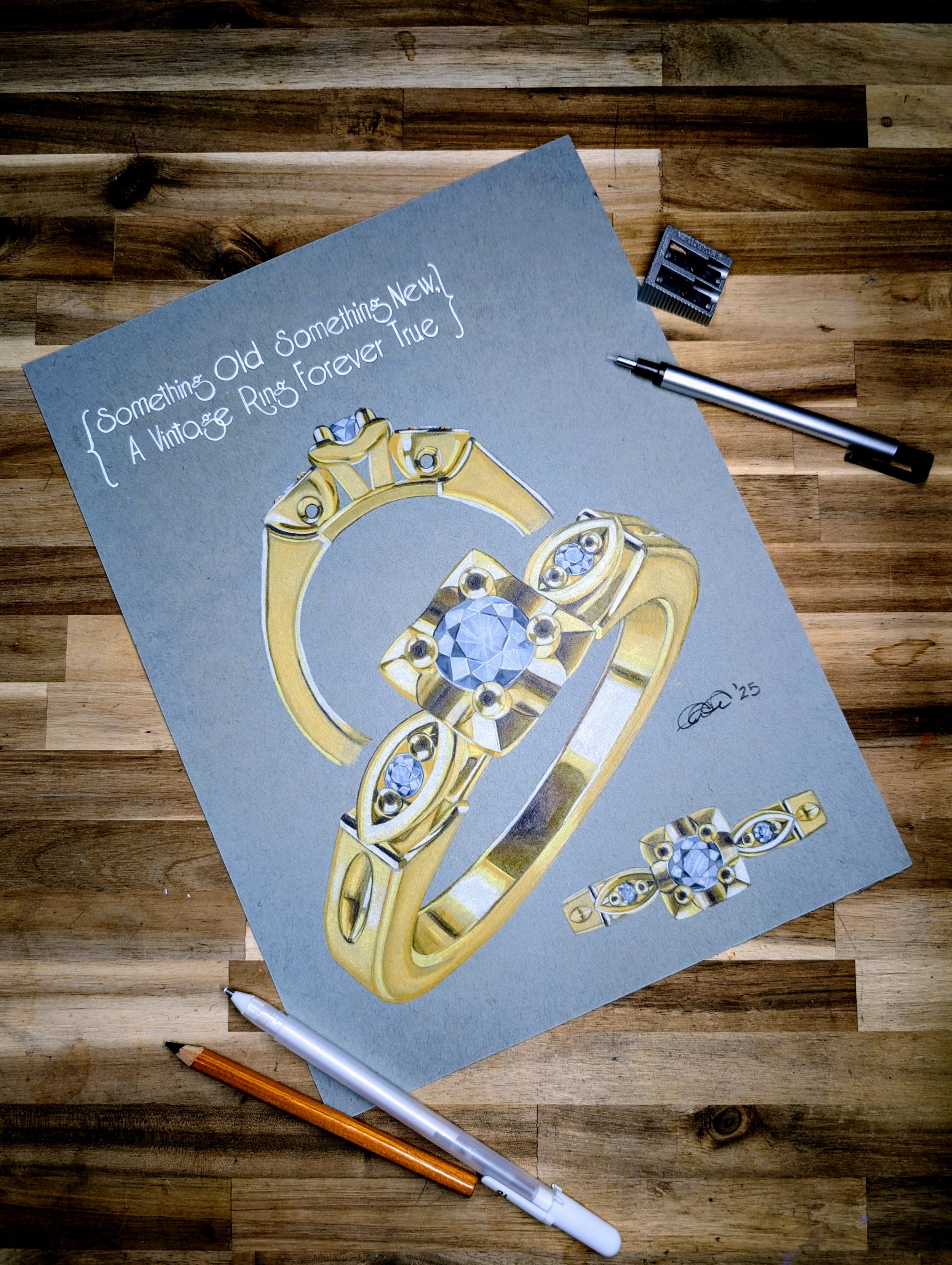 A drawing of a gold ring with a large diamond and smaller stones, on a gray background with handwritten notes, pens, and a sharpening tool on a wooden surface.