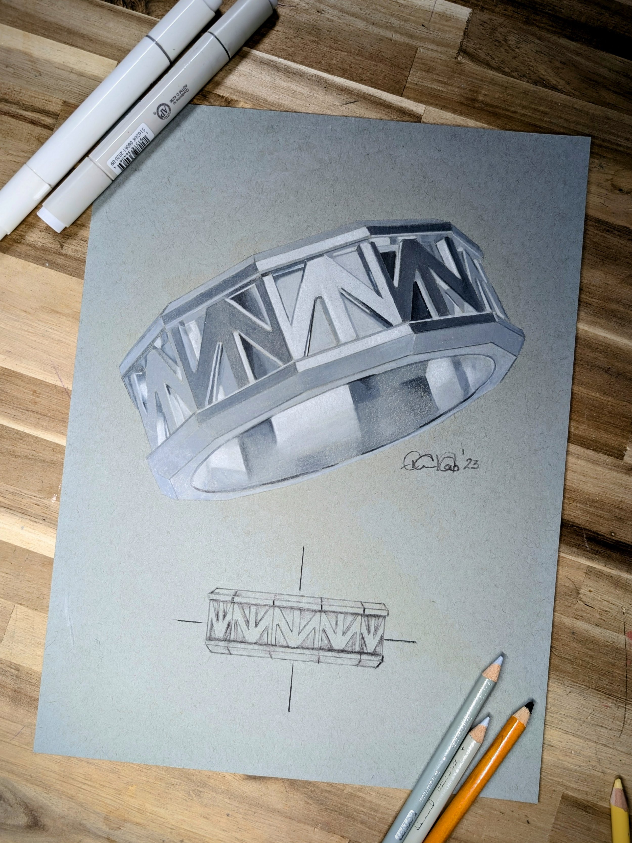 A detailed watercolor drawing of a modern, open-worked ring with geometric patterns, mounted on a gray background. Below the drawing is a technical sketch of the ring with annotations. Several colored pencils are placed nearby.