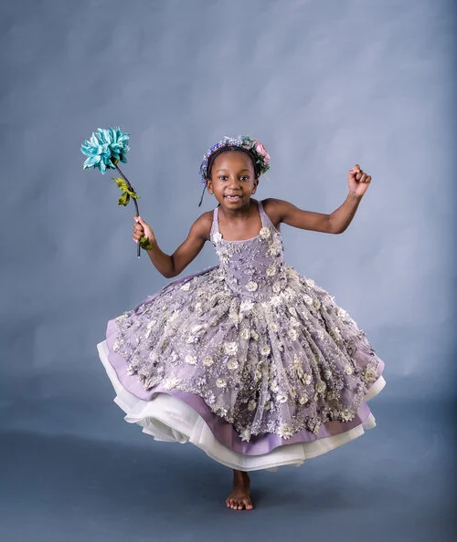 6+year+old+holding+teal+flowers+in+purple+puffy+dress+at+Seraphine+Photography+Studio+in+Randolph+MA-3713.jpg