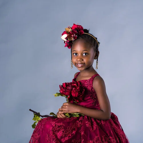 5+year+old+posed+in+red+dress+and+flower-.jpg