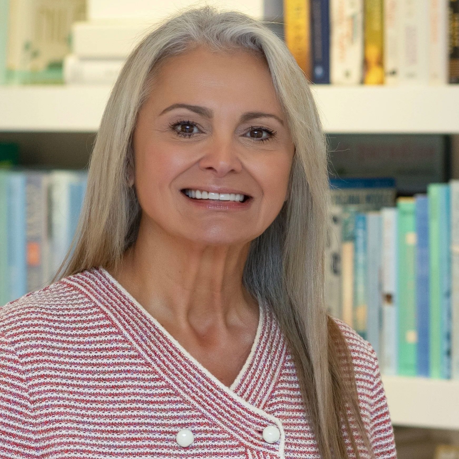 Smiling woman with gray hair in an art gallery or museum