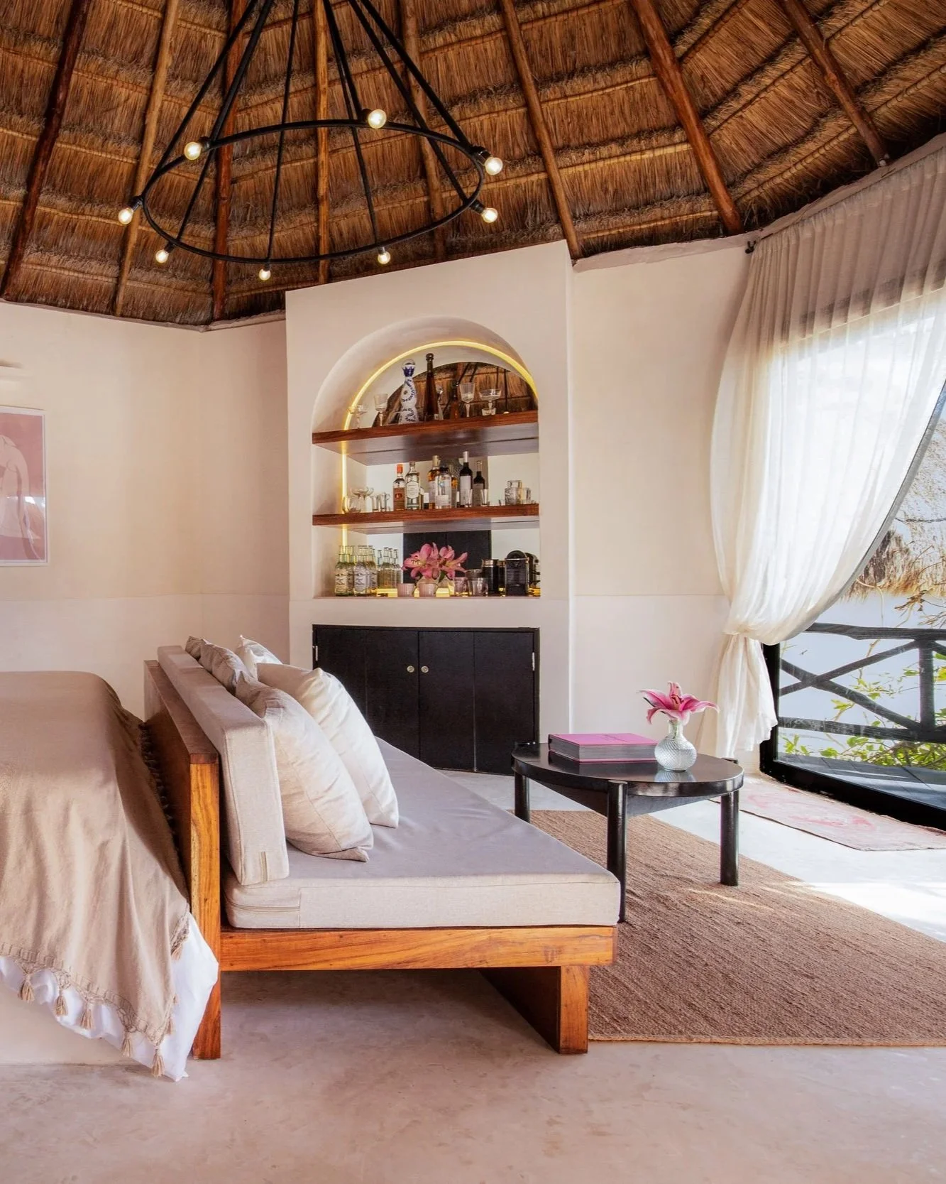 Chic bedroom with natural textures, soft lighting, and open layout at Casa Gitano Tulum.