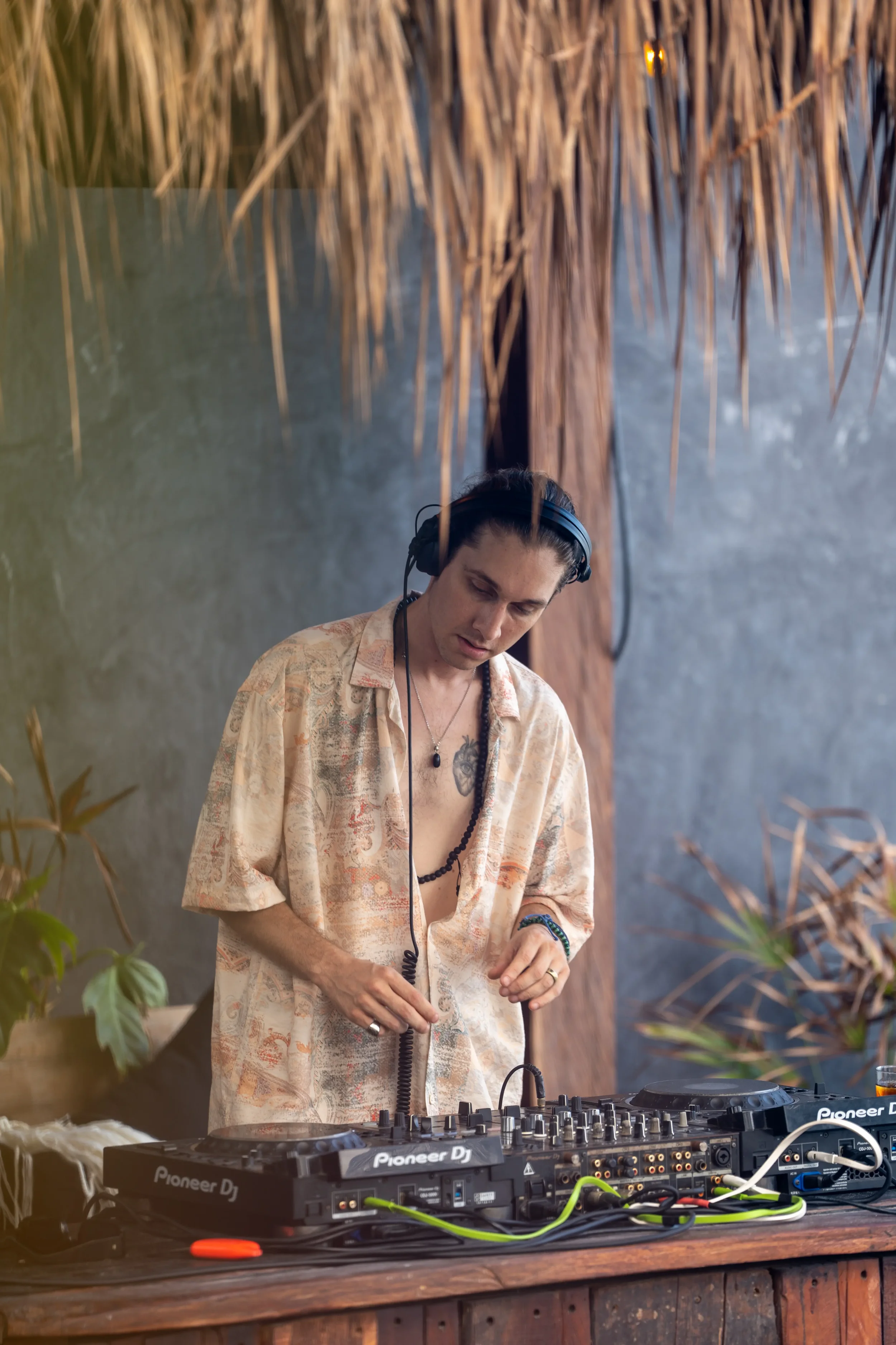 DJ Versa in the DJ palapa at Gitano Beach