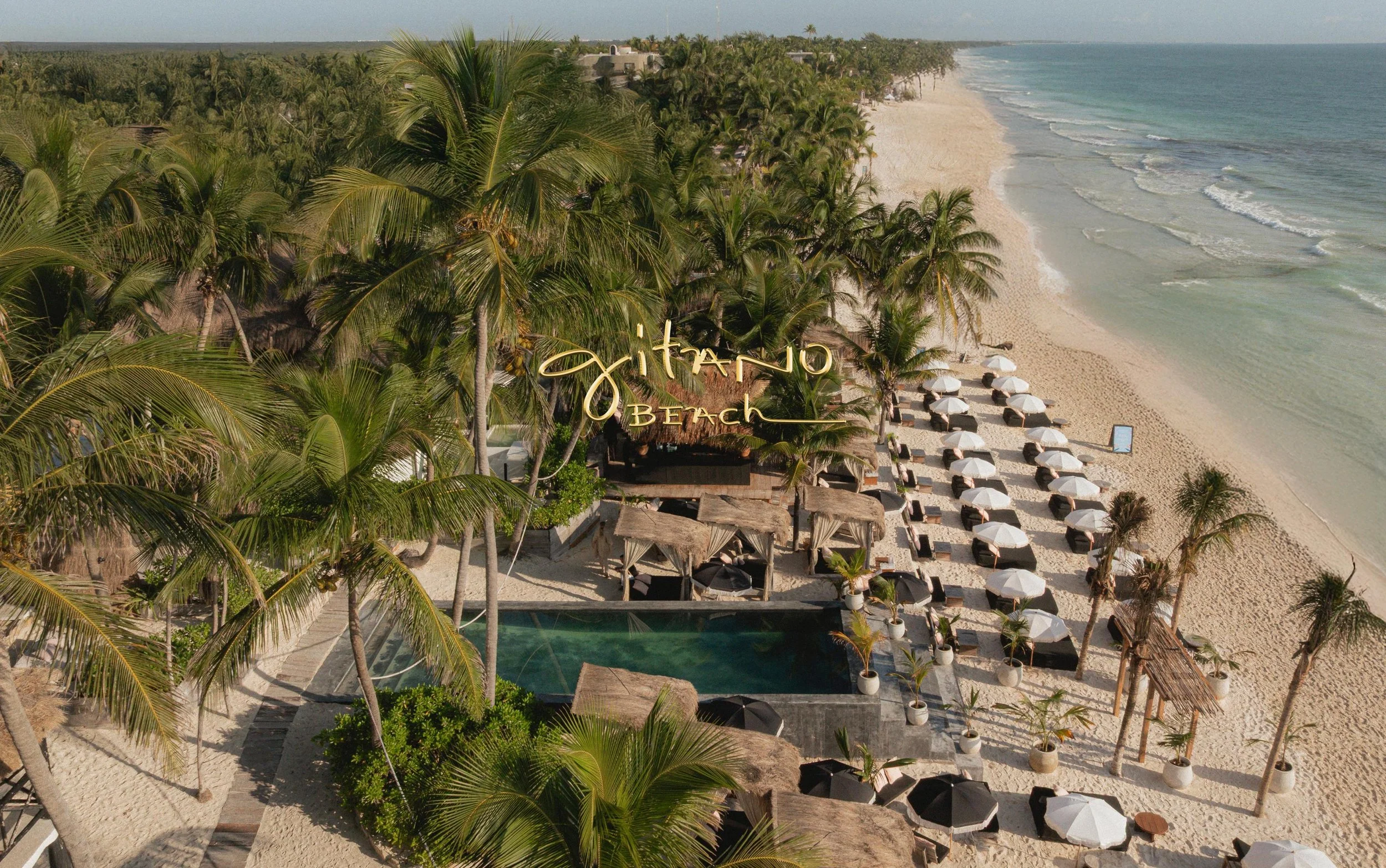 Aerial shot of Caribbean water, pristine beach, GITANO BEACH CLUB, CASA GITANO and surrounding jungle 