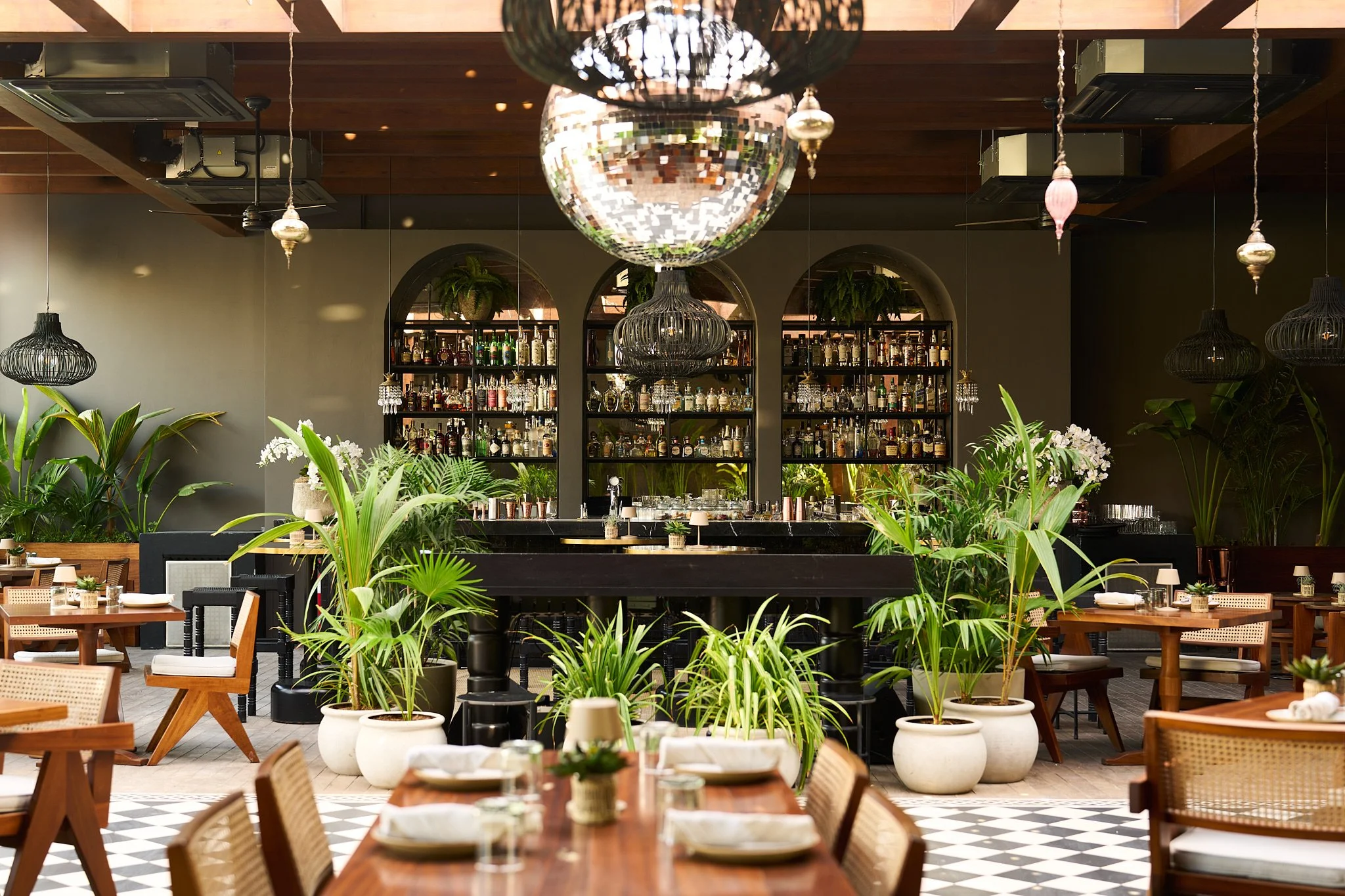 Beachfront view of CASA GITANO in Tulum, with pristine white sand, swaying palm trees, and chic private villas steps from the turquoise sea.