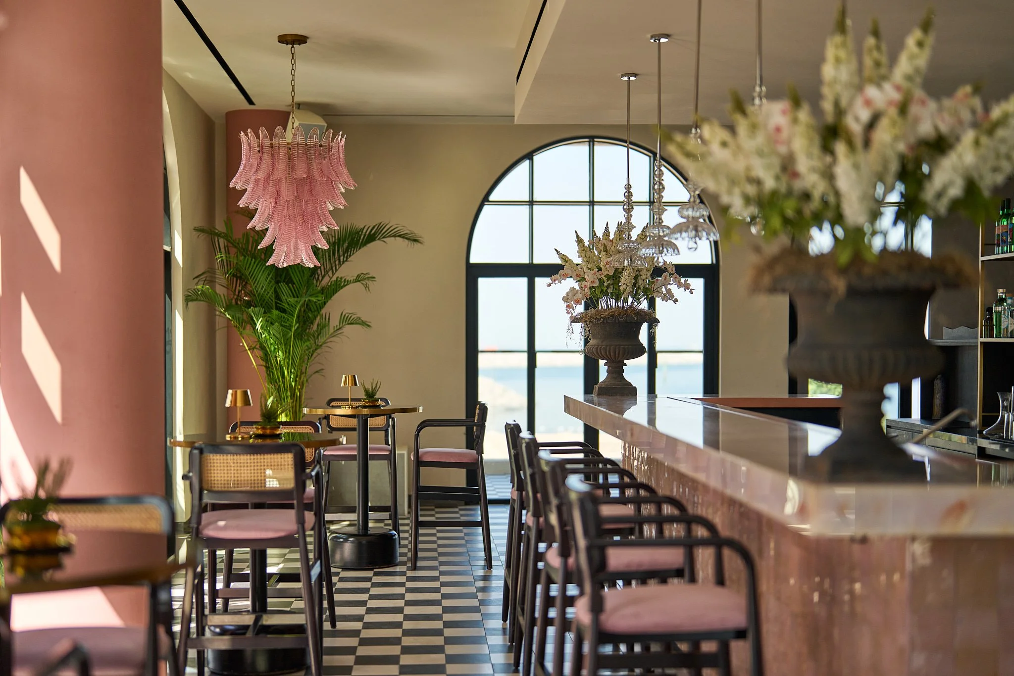 Beachfront view of CASA GITANO in Tulum, with pristine white sand, swaying palm trees, and chic private villas steps from the turquoise sea.