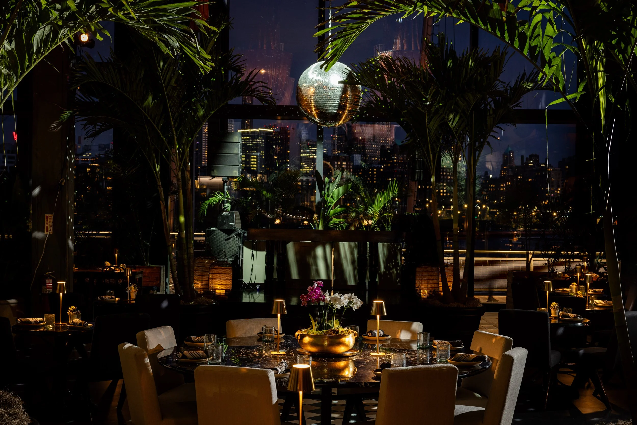 A stylish group of guests at GITANO NYC, gathered around a candlelit dinner table. Chic fashion, bold personalities, and bohemian glamour set the scene for an unforgettable night in the heart of the city.