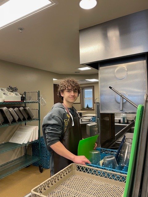 Evan Hollenhorst has been volunteering at Community Kitchen since the summer of 2024. A senior at Bloomington South, he is currently fulfilling an internship with us through the end of this trimester in February. Born in Salt Lake City, Evan moved he