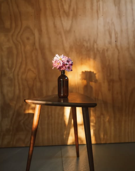 A vase of flowers on a table inside The Cosmos Co cabin 