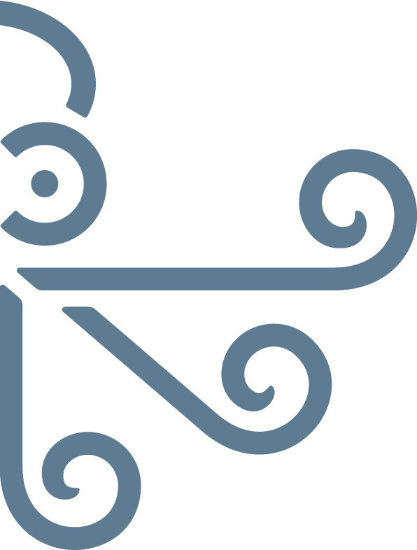 A decorative metal corner piece with curling and swirling patterns, likely part of furniture or architectural detail.