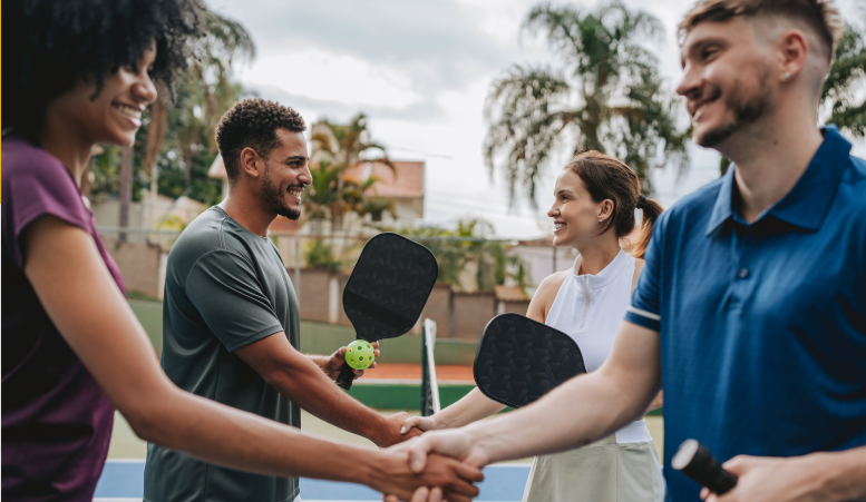 2 males and 2 females shaking hands after playing Padel.