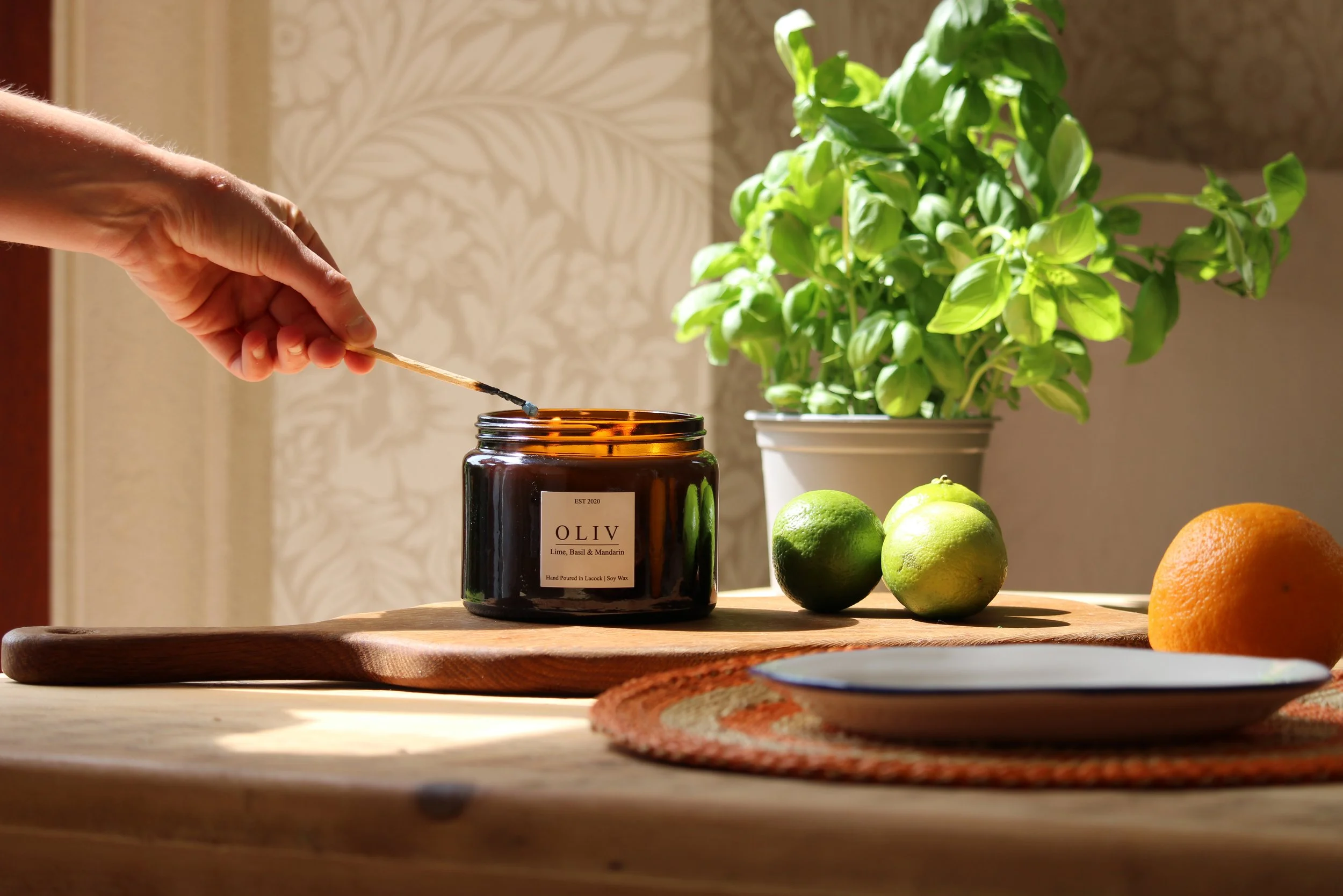 lime basil and mandarin candle being lit.JPG