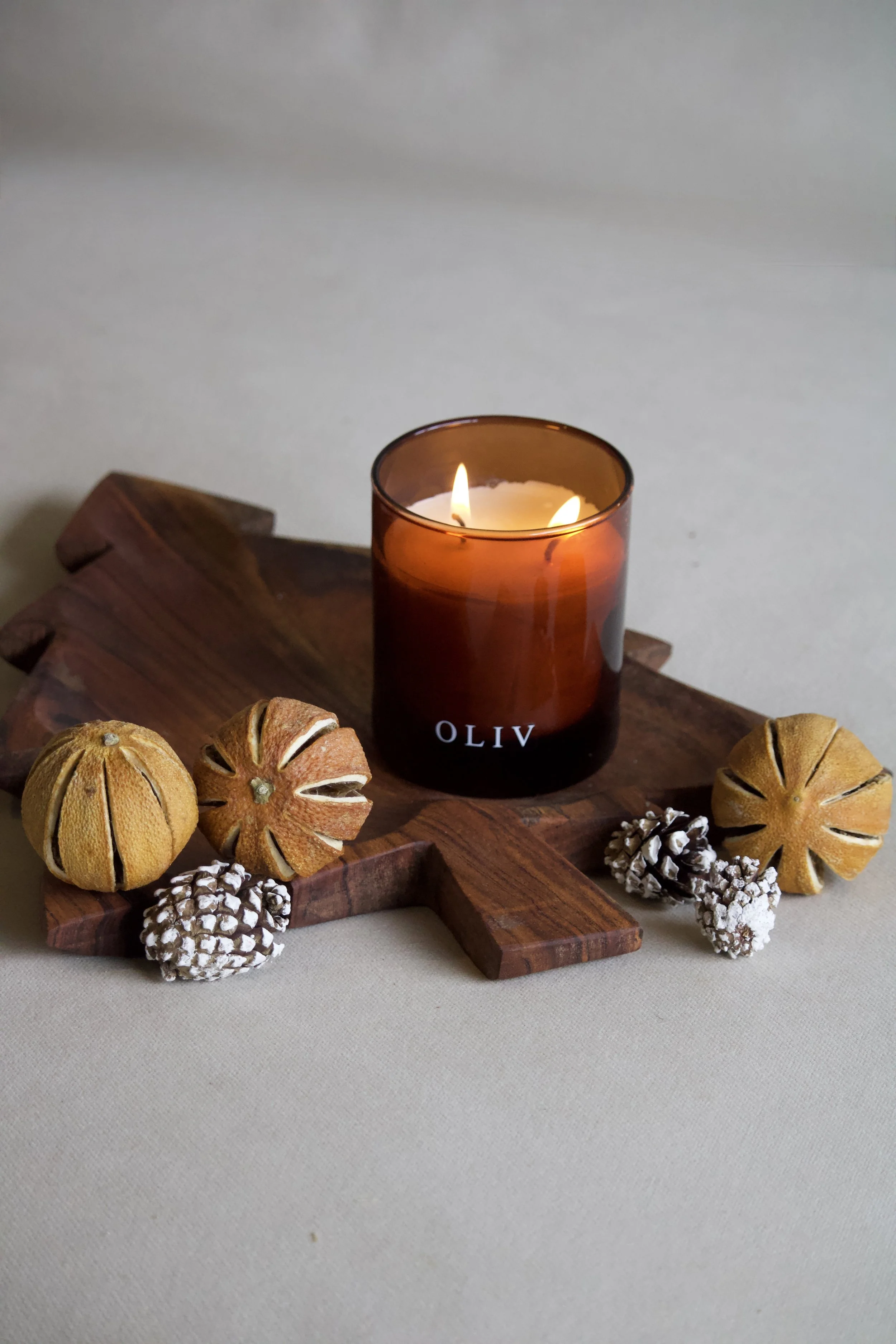 oliv christmas dual wick candle amber lit.jpg