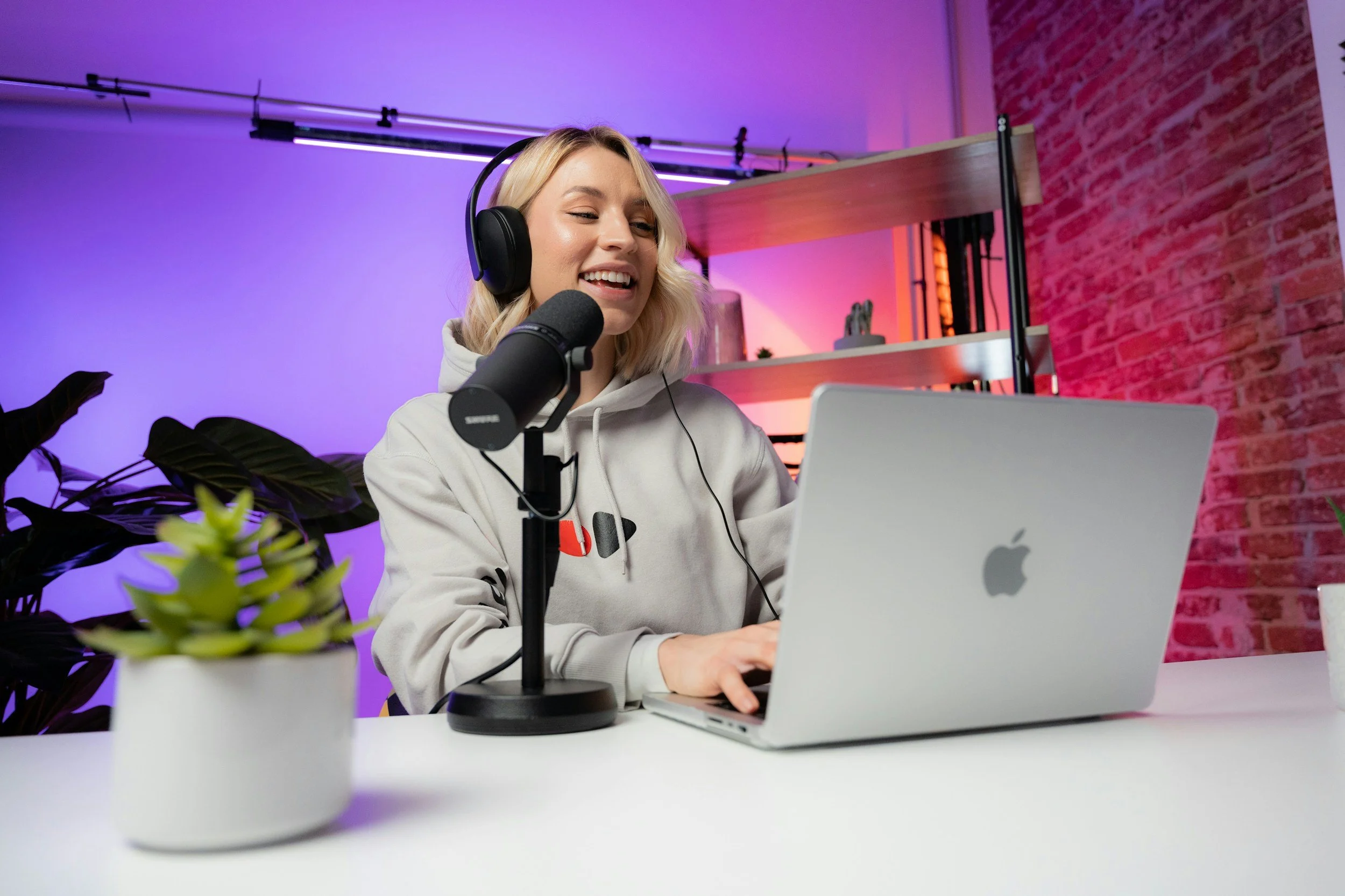 Girl in Grey Jumper creating a podcast