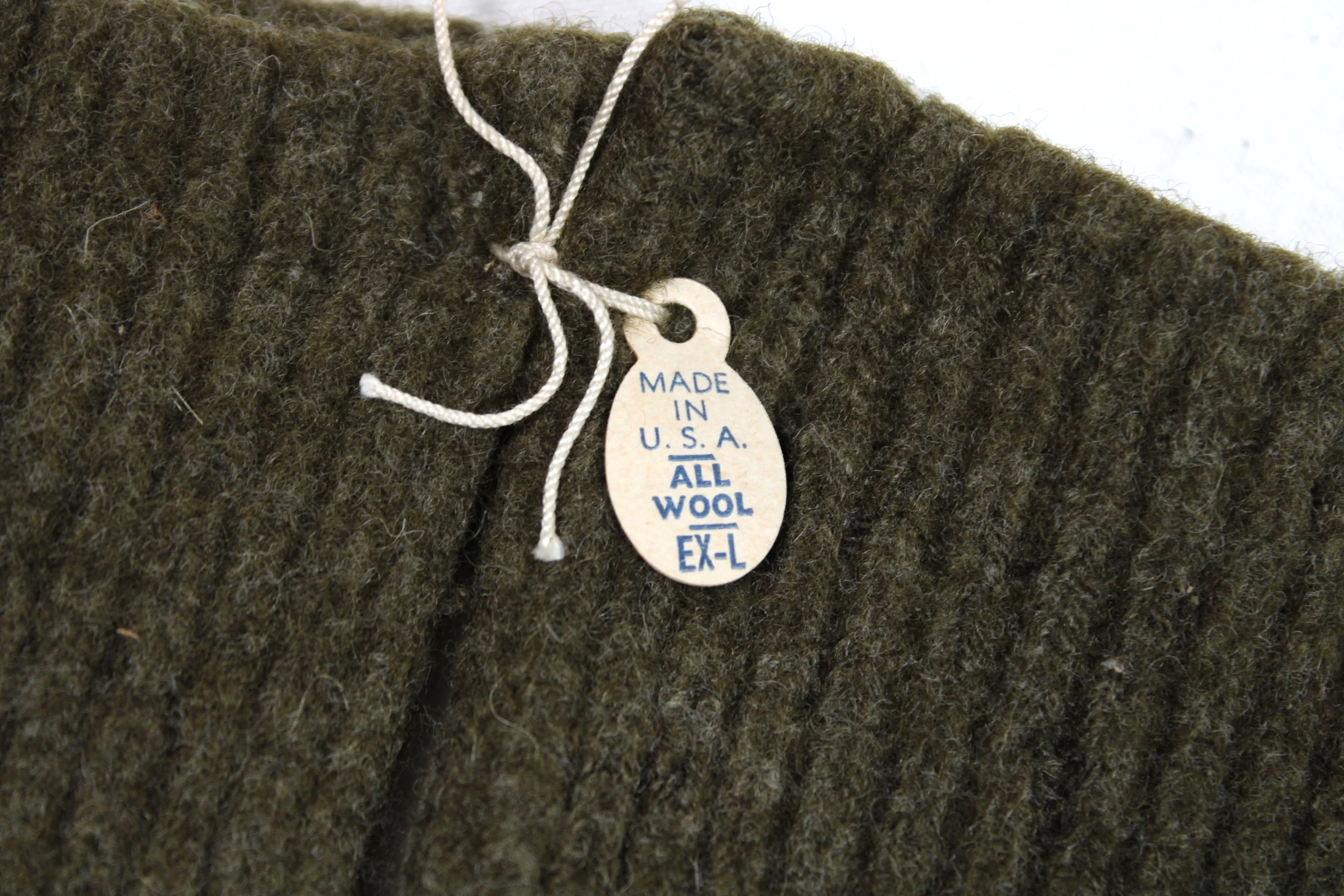 Genuine WWII pair of US mittens, OD wool, with trigger finger. Type II with trigger finger located inside the palm. The index finger is left free to activate the weapon's trigger.