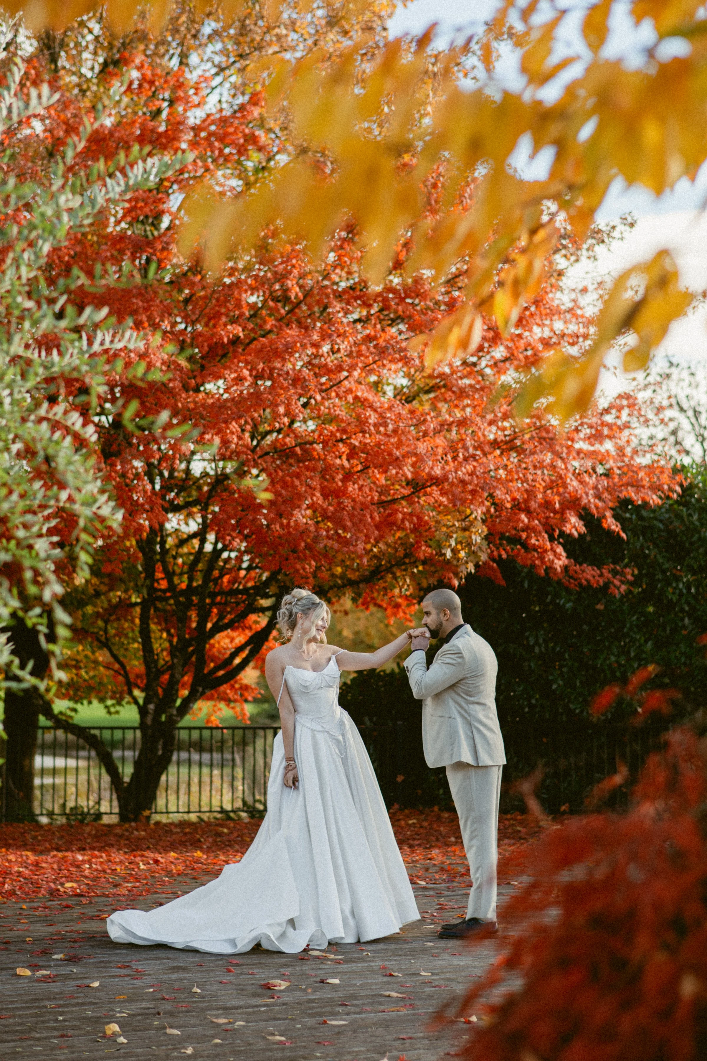Bride and groom sharing a quiet moment surrounded by autumn foliage at Swaneset Bay Resort.