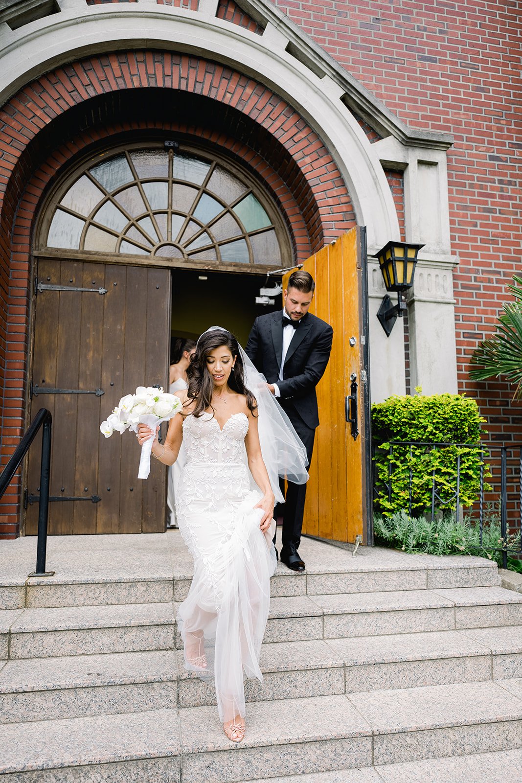 Glamorous Bride struts down stairs after wedding recessional in Vancouver ceremony 