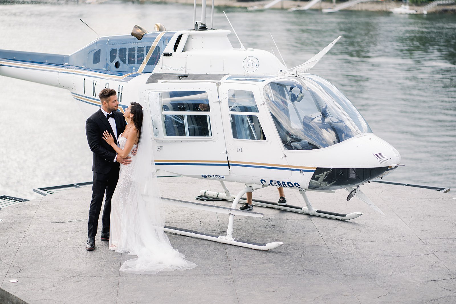 Wealthy Vancouver couple gazes into each other eyes before literally and metaphorically rising above rest of local Vancouver population in helicopter. 