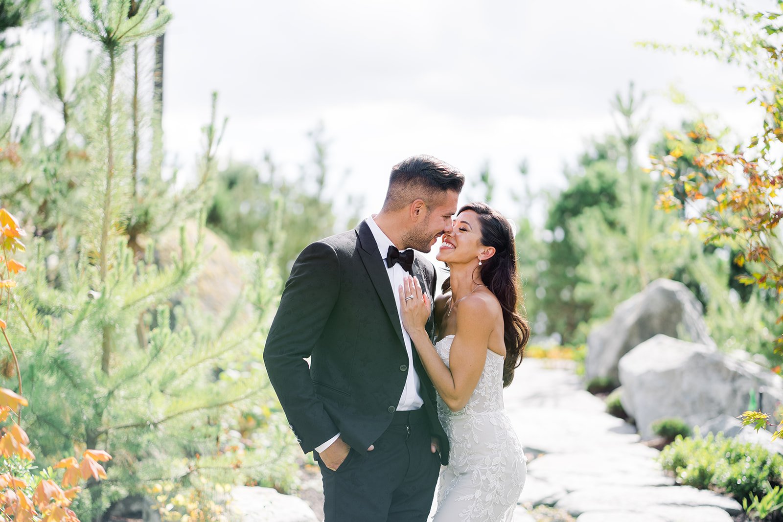 Bride and Groom lock loving gazes in lush pacific northwest garden during Vancouver wedding