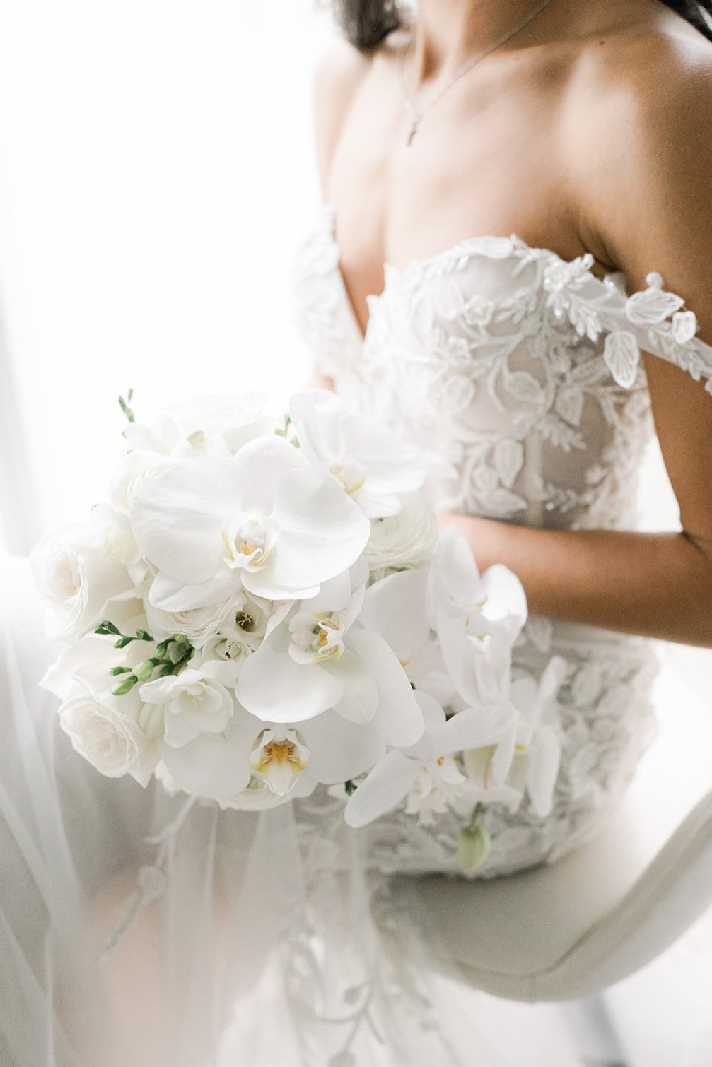 bride holds elegant orchid and rose bouquet before wedding ceremony in Vancouver British Columbia