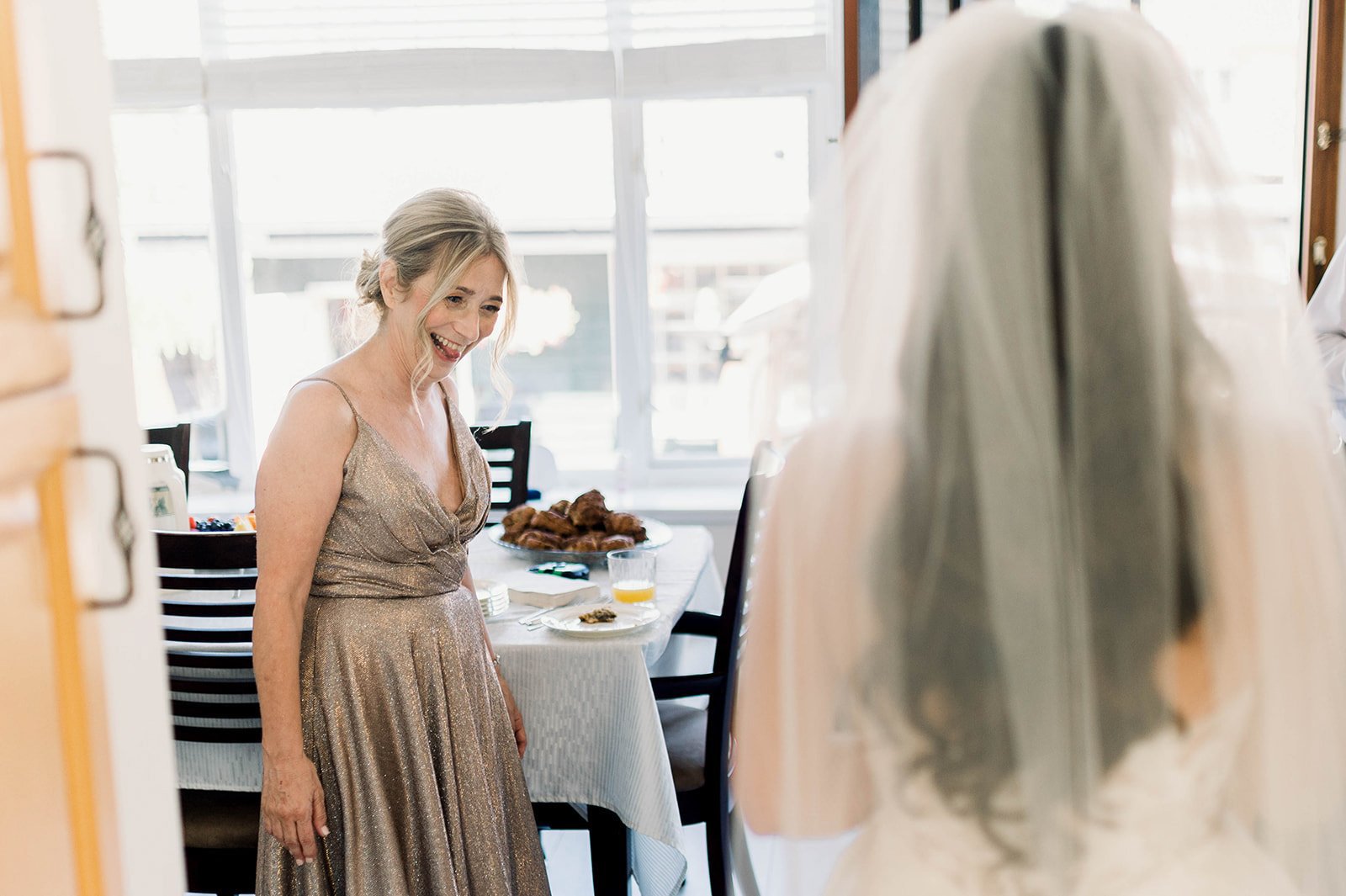 Bridesmaid shocked at how good her friend looks in her wedding dress on the morning of a hart house wedding.