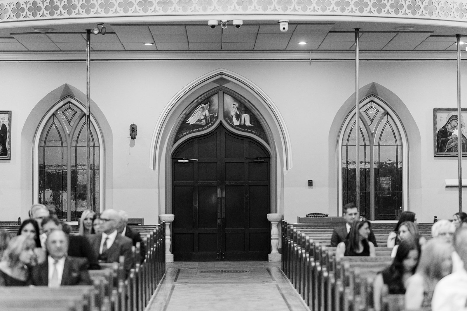 Angels adorn curved church doorway of ceremony location, photographed by Beautiful life studios, BC 