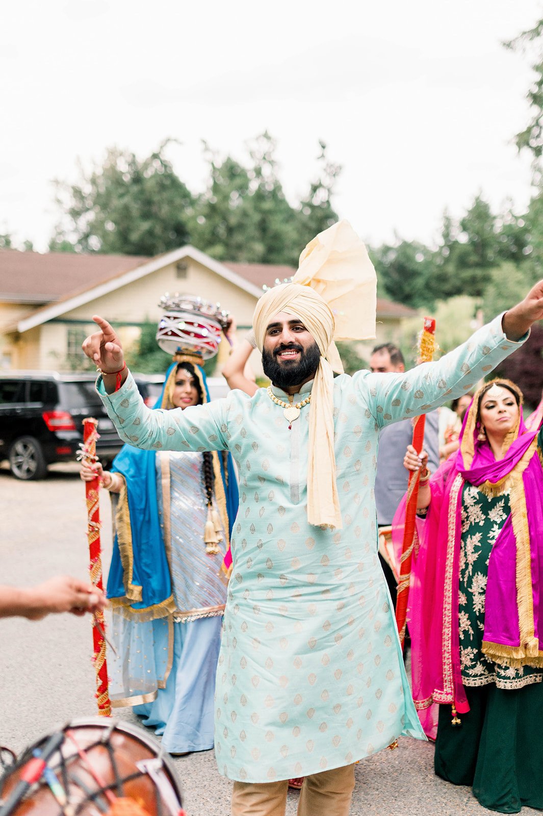 Groom dances in blue tunic and turban as he enters pre-wedding ceremony in Victoria BC.