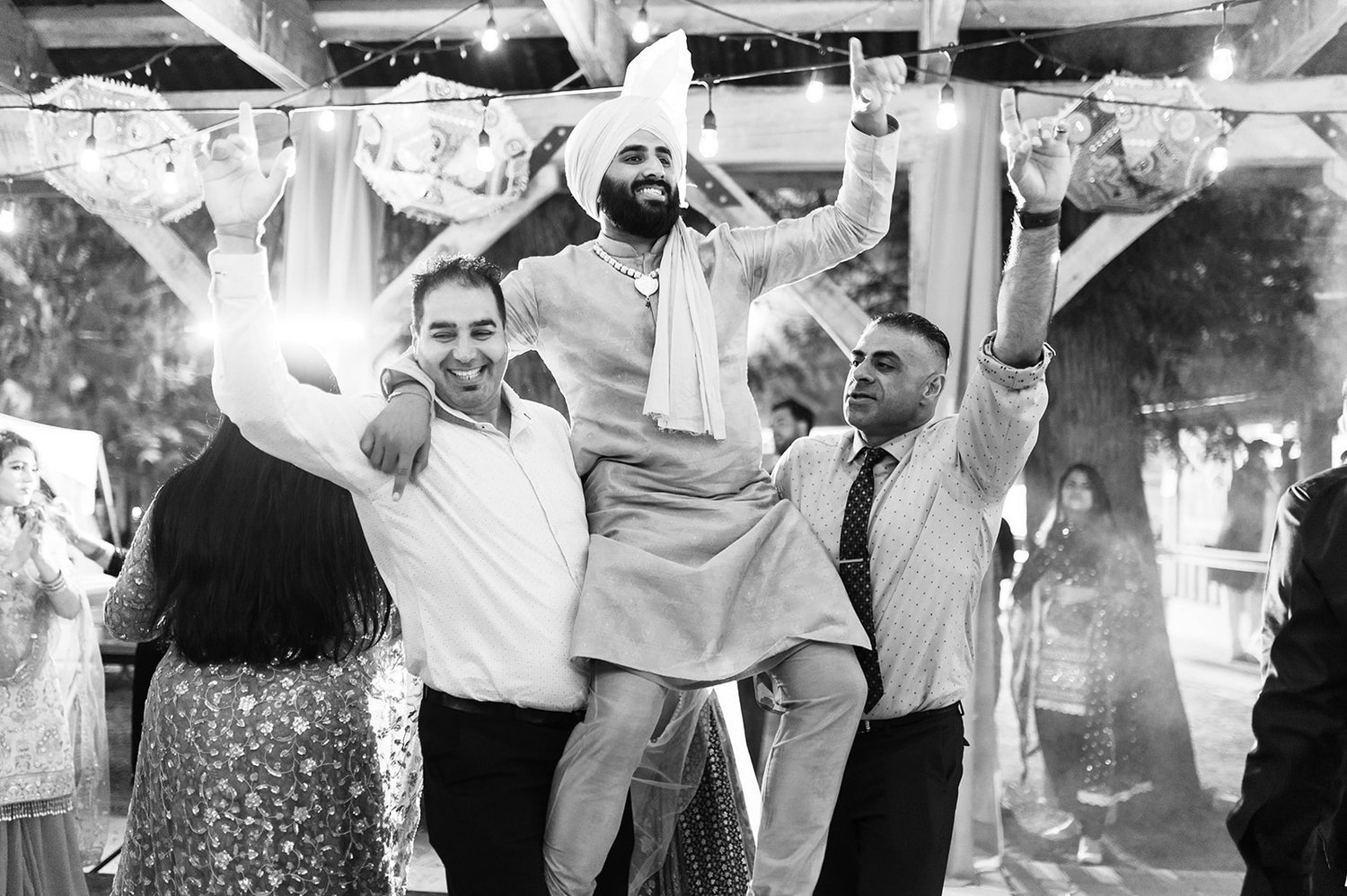 Groom is lifted into air at his Jaggo before his Victoria BC wedding.