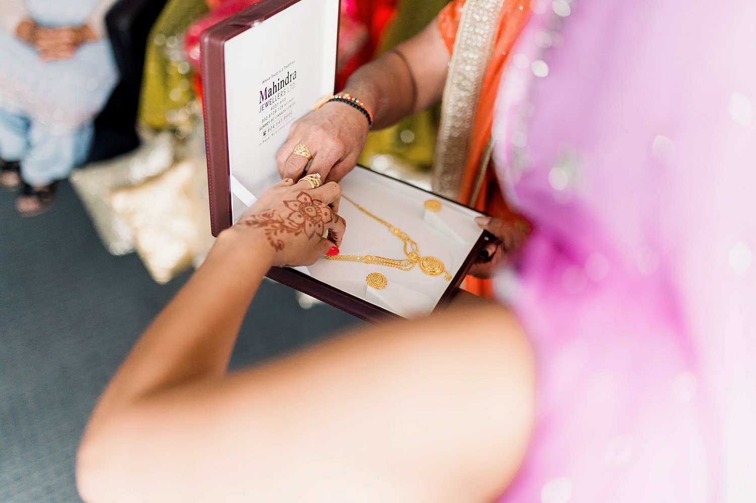 A gold necklace is given as a wedding gift during an Indian Choora Ceremony. 
