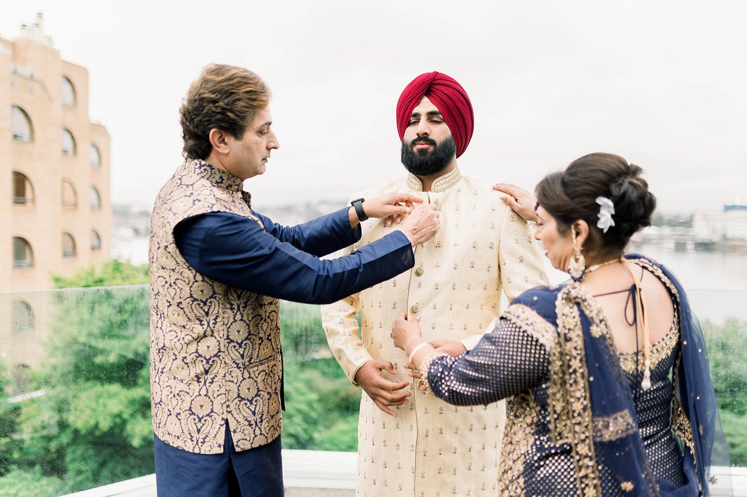 Mom and Dad make finial adjustments to their son before he heads into his Sikh wedding Ceremony in Victoria BC. 
