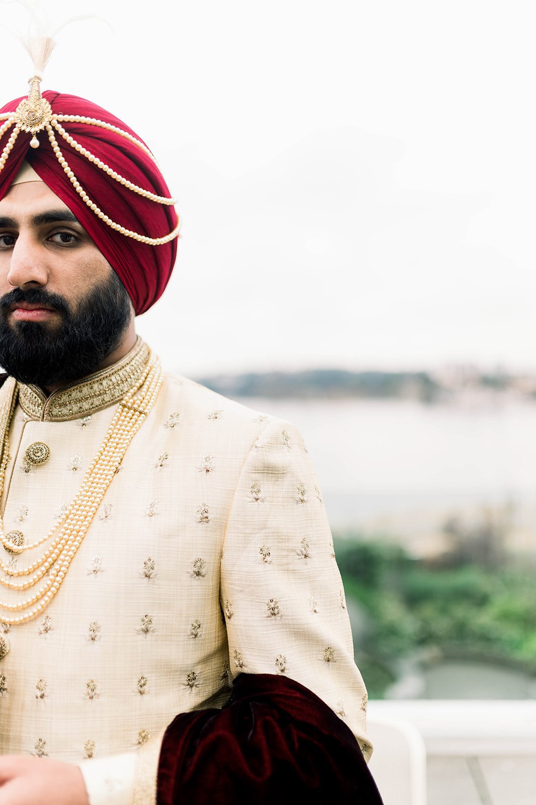 A stern looking groom stares into the abyss before his traditional indian wedding ceremony. 