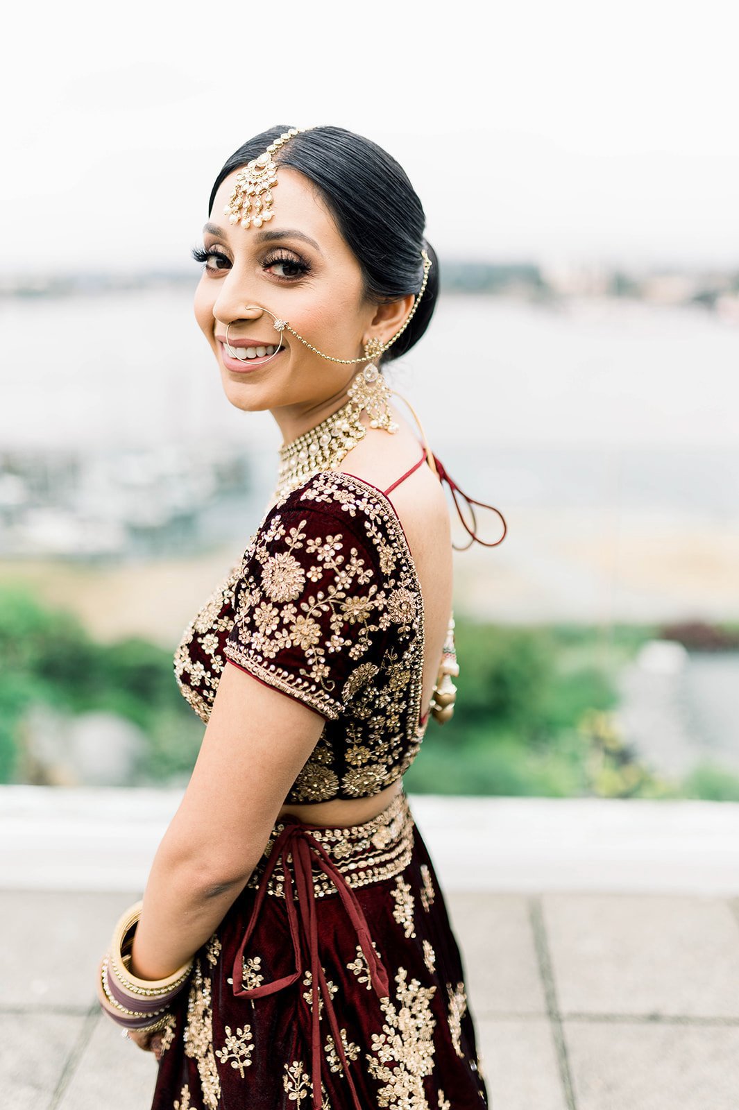 An indian bride smiles at Beautiful Life wedding photographer on her wedding day in Victoria BC. 