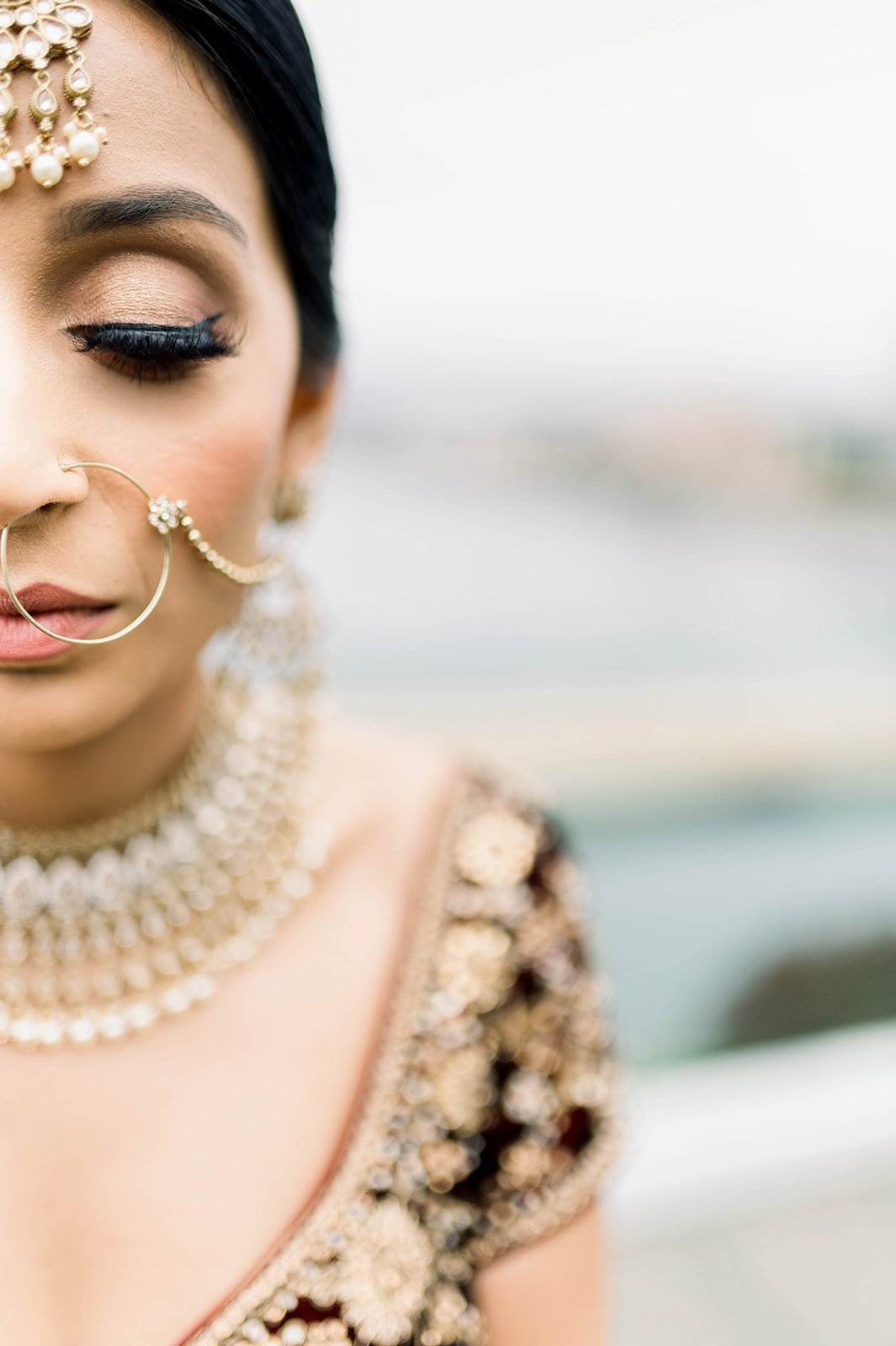 A South Asian bride takes a quiet moment to ponder her wedding day before her traditional Punjabi wedding in Victoria BC 