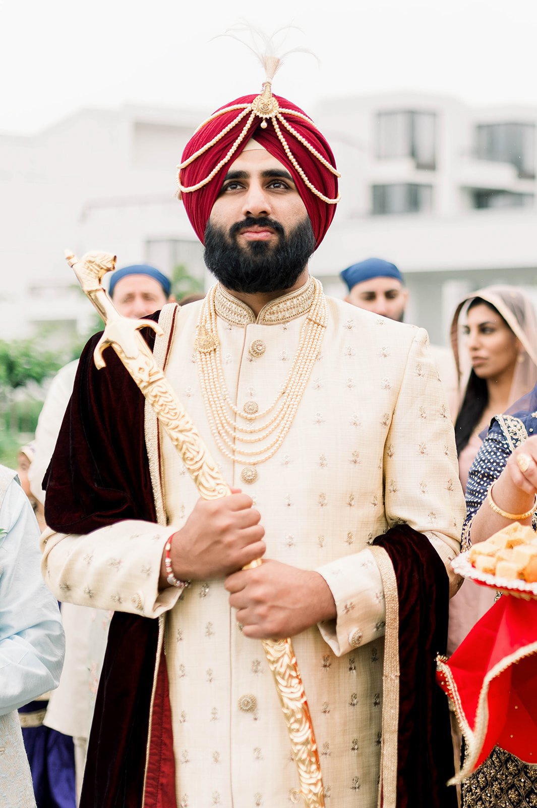 An Indian Groom clutches a sword as he enters the ceremony venue in Victoria BC